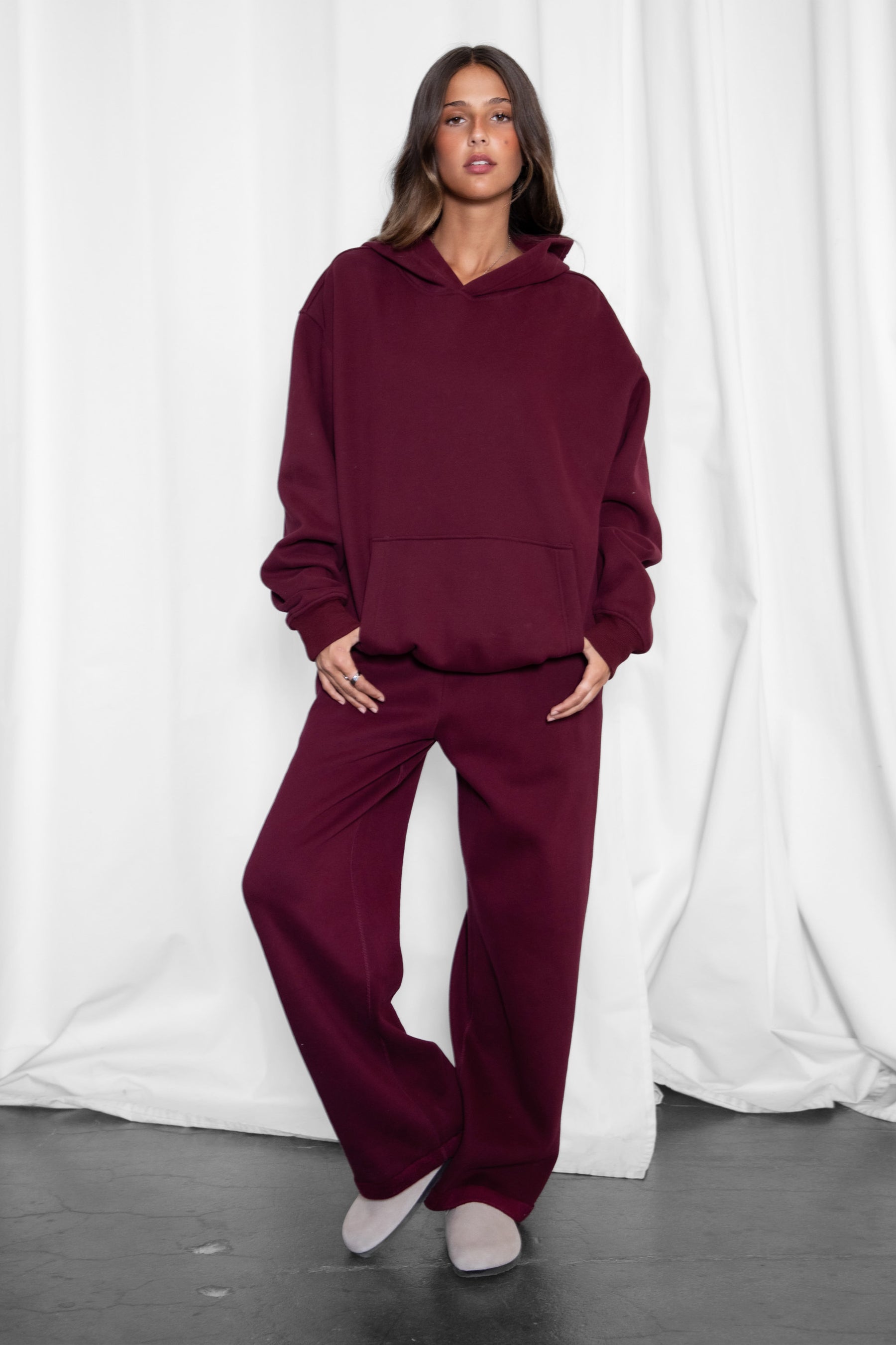 Woman wearing the TIC TOC PJ30241 LANI black cherry cloud fleece wide leg sweatpants featuring a straight leg silhouette, drawcord waistband, and side pockets paired with a matching hoodie.
