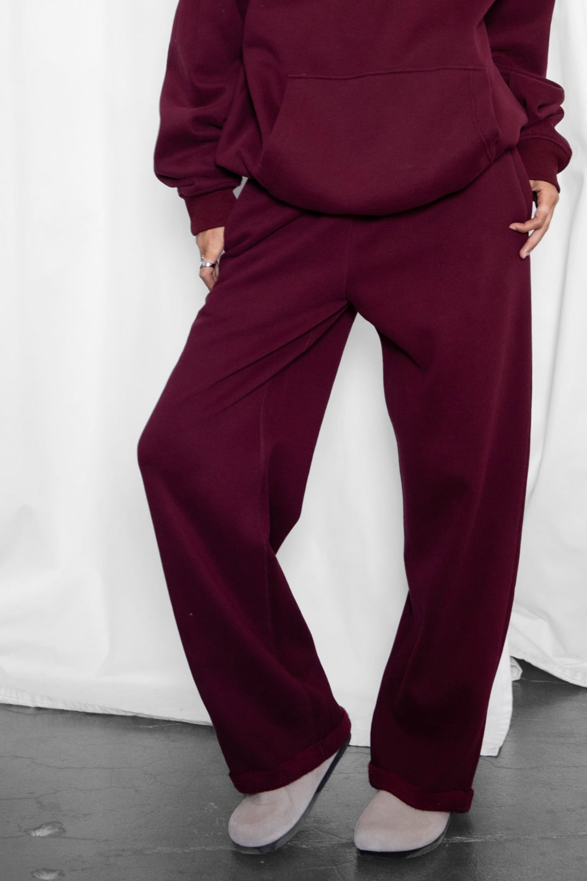 Woman wearing the TIC TOC PJ30241 LANI black cherry cloud fleece wide leg sweatpants featuring a straight leg silhouette, drawcord waistband, and side pockets paired with a matching hoodie.