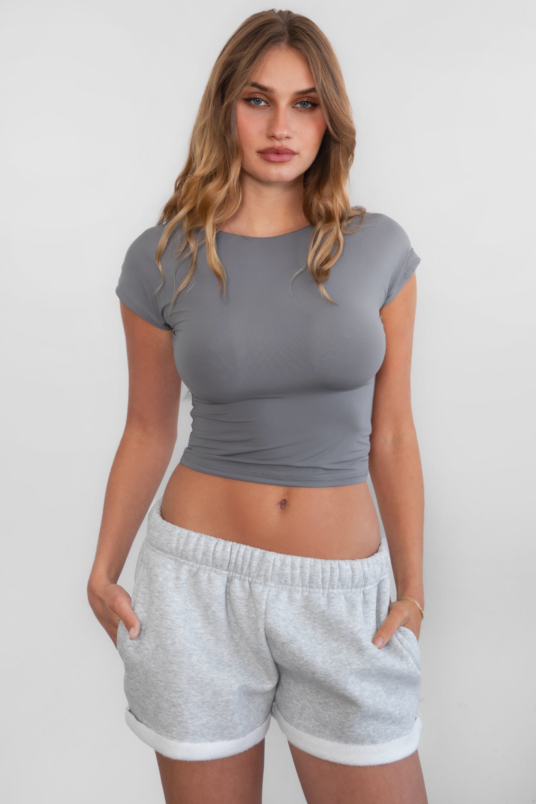 TIC TOC KENDALL Open Back Short Sleeve Baby Tee in charcoal featuring low back detail and silky spandex fabric.