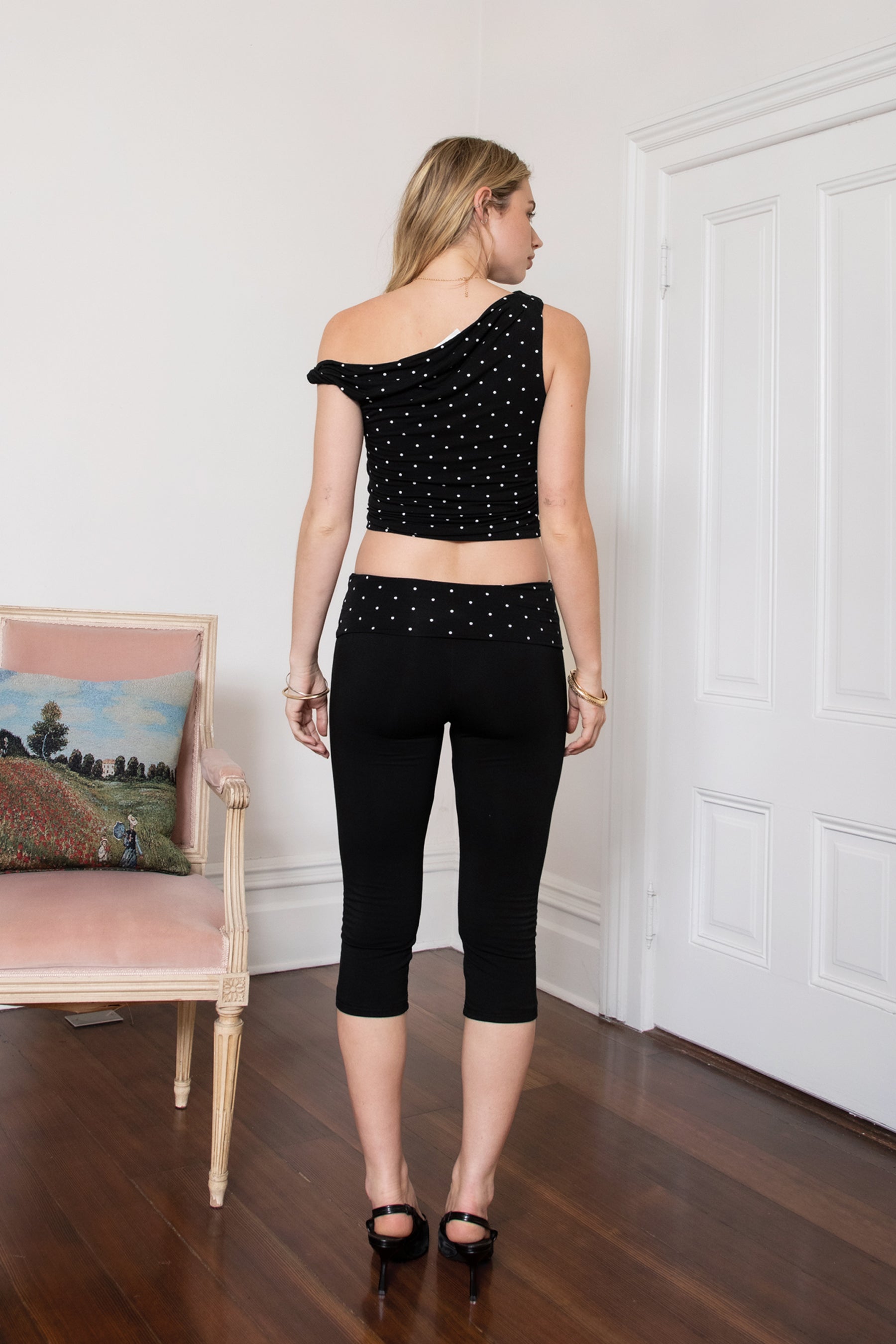Woman wearing TIC TOC PH31999 SORA rayon fold over waist polka dot capri leggings pants featuring a smooth stretch fabric, contrast polka dot fold-over waistband, mid-rise fit, slim body-hugging silhouette, and clean capri length for a sporty feminine everyday look.