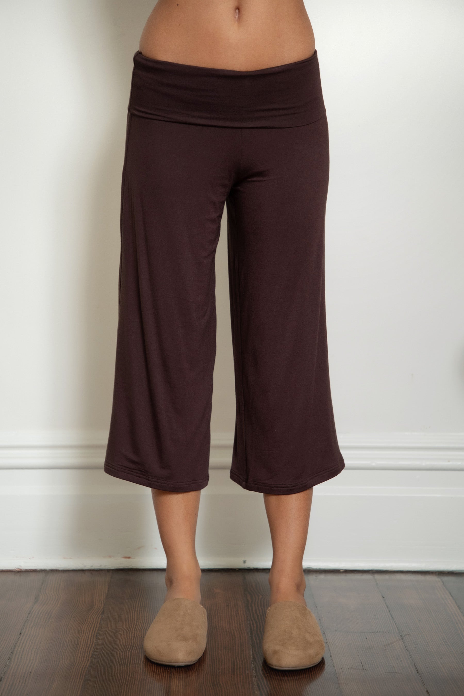 Woman wearing TIC TOC PH32000 SORA rayon spandex fold over low rise wide leg leggings featuring a soft lightweight jersey fabric, fold-over waistband, relaxed wide leg silhouette, and capri length, styled for a clean laid-back lounge and everyday look.