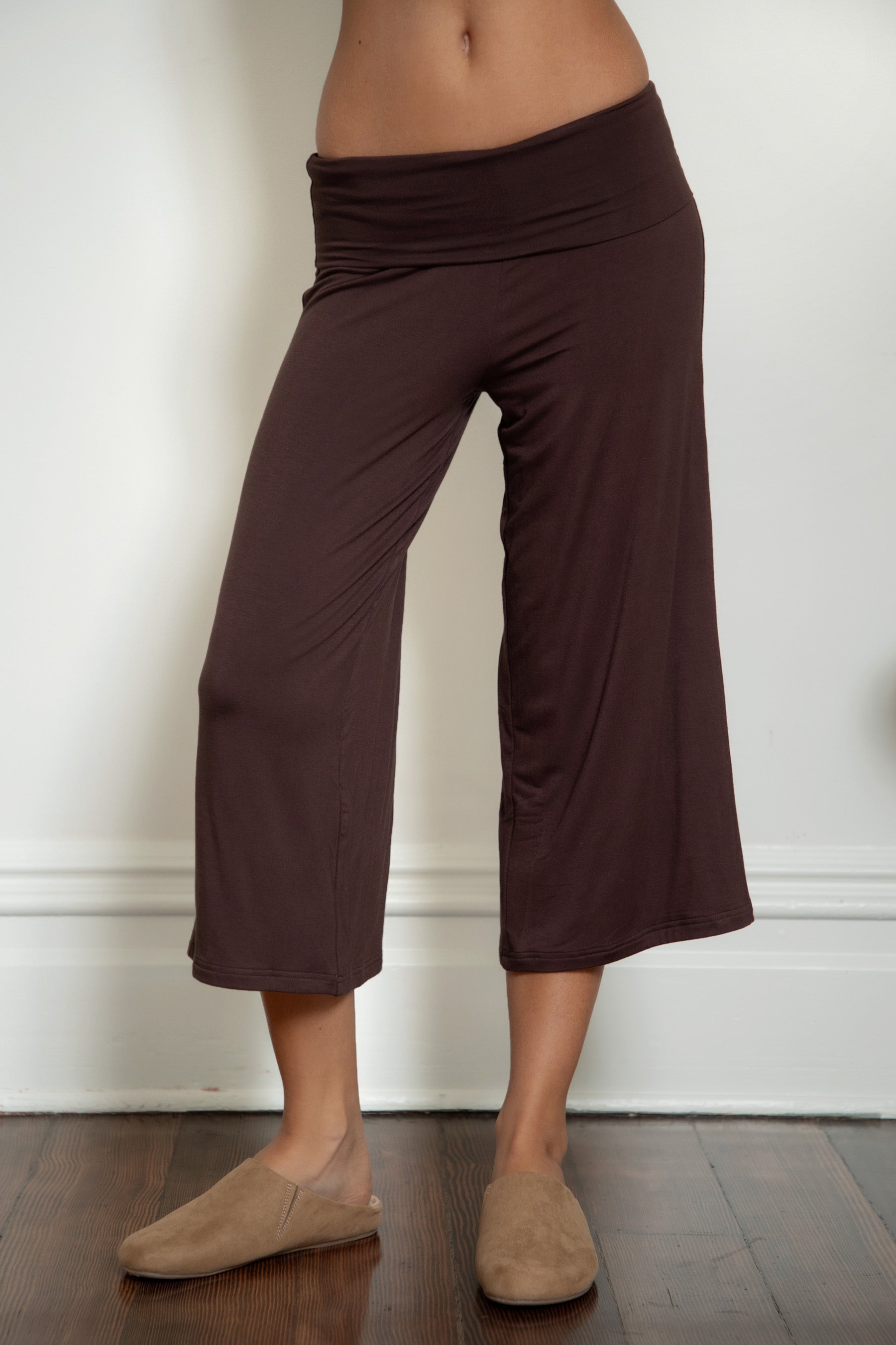 Woman wearing TIC TOC PH32000 SORA rayon spandex fold over low rise wide leg leggings featuring a soft lightweight jersey fabric, fold-over waistband, relaxed wide leg silhouette, and capri length, styled for a clean laid-back lounge and everyday look.