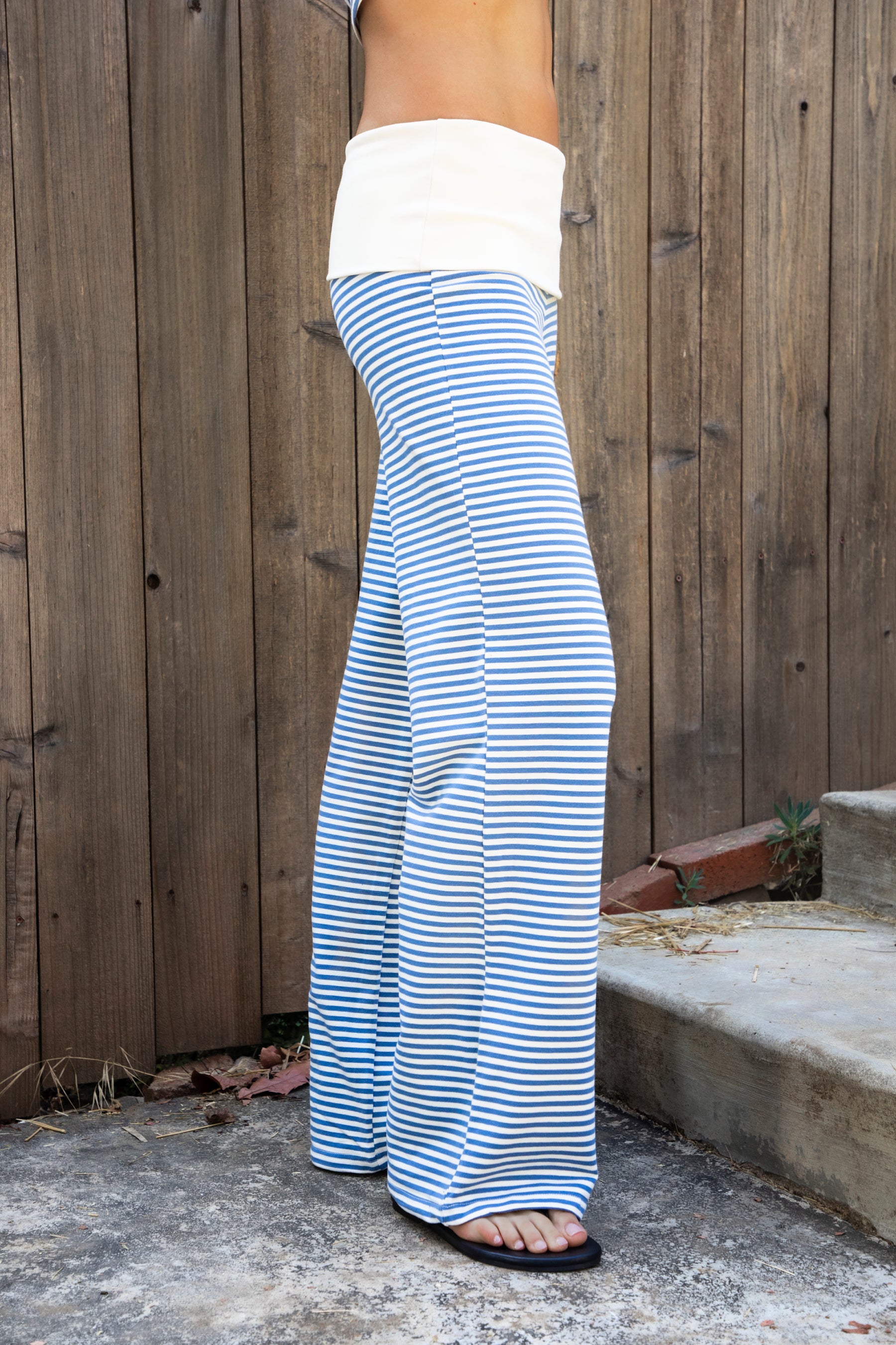 Woman wearing BRISA French terry stripe foldover waist wide leg pants featuring soft stretch French terry fabric, contrast foldover waistband, flattering low rise look, relaxed wide leg silhouette, classic stripe pattern, and pull on design for easy lounge and travel styling.
