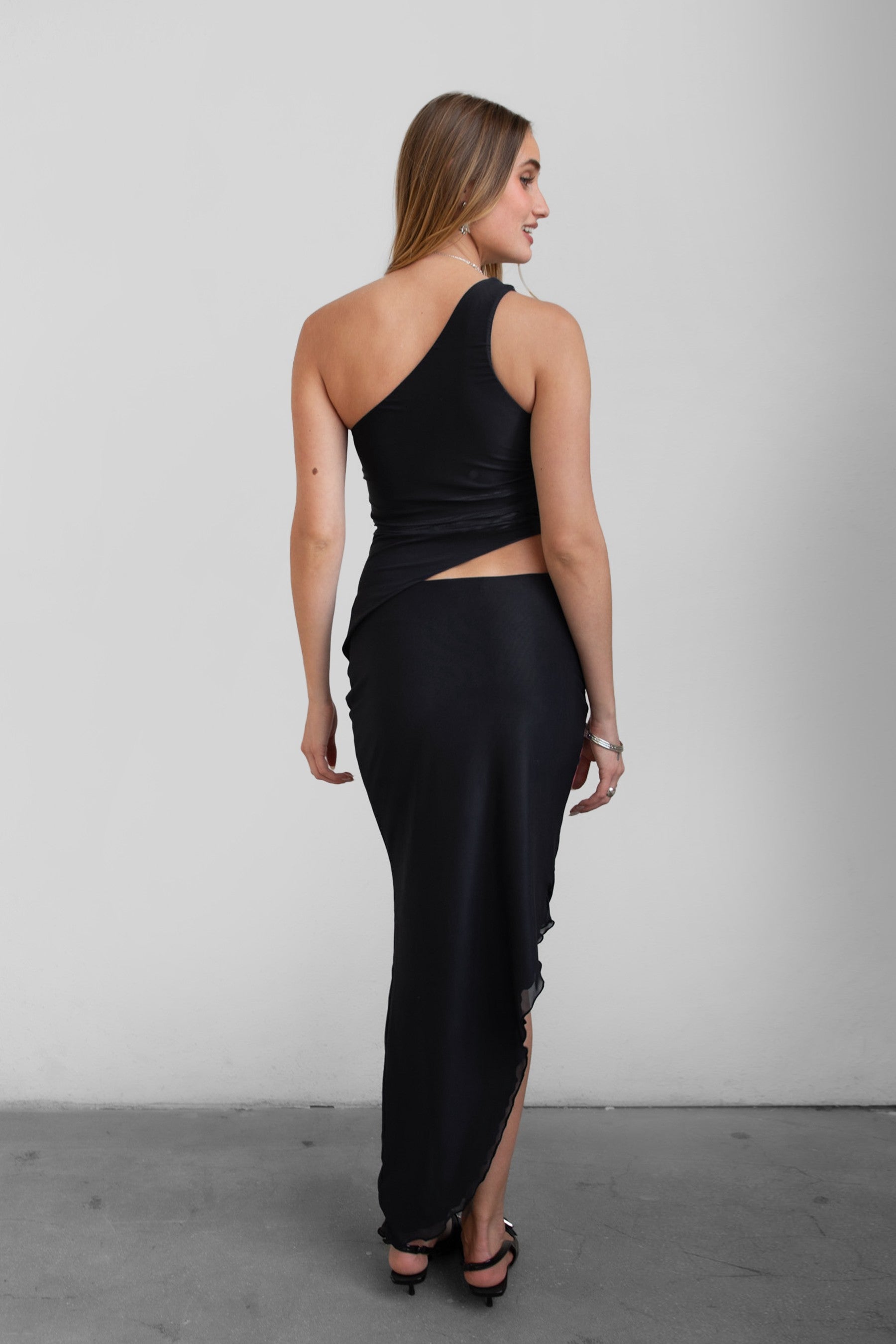 TIC TOC MUAH S Mesh Print Asymmetrical Skirt in Black and red with mid rise stretch waistband and angled hem.