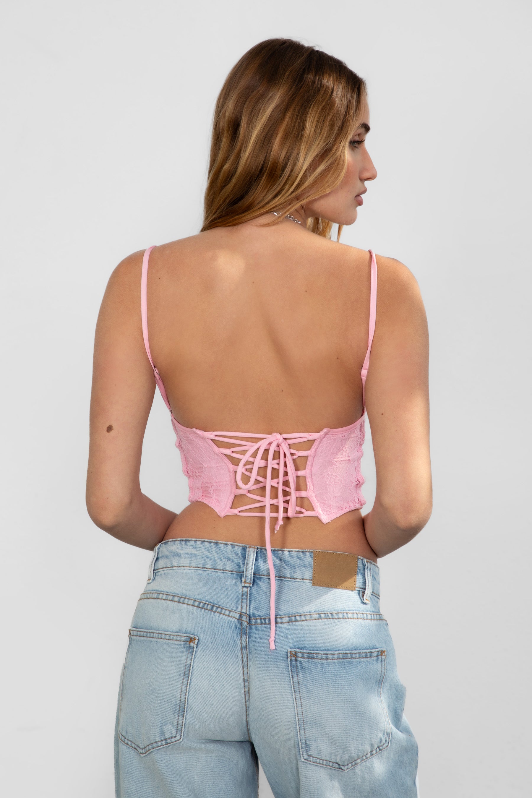 TIC TOC BAYLOR Lace Bustier Top in blush with sweetheart neckline, lace-up back, and boned curved hem design.
