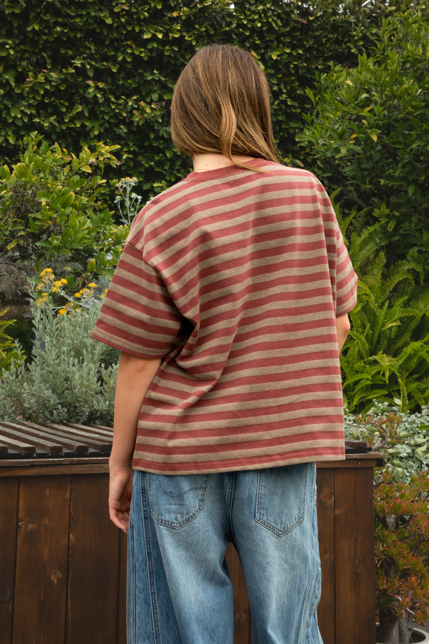Woman wearing MARIN classic crewneck oversized striped short sleeve top featuring a timeless crew neckline, relaxed oversized fit, drop shoulder sleeves, soft horizontal stripe pattern, breathable 100% cotton fabric, and clean straight hem for everyday casual styling.