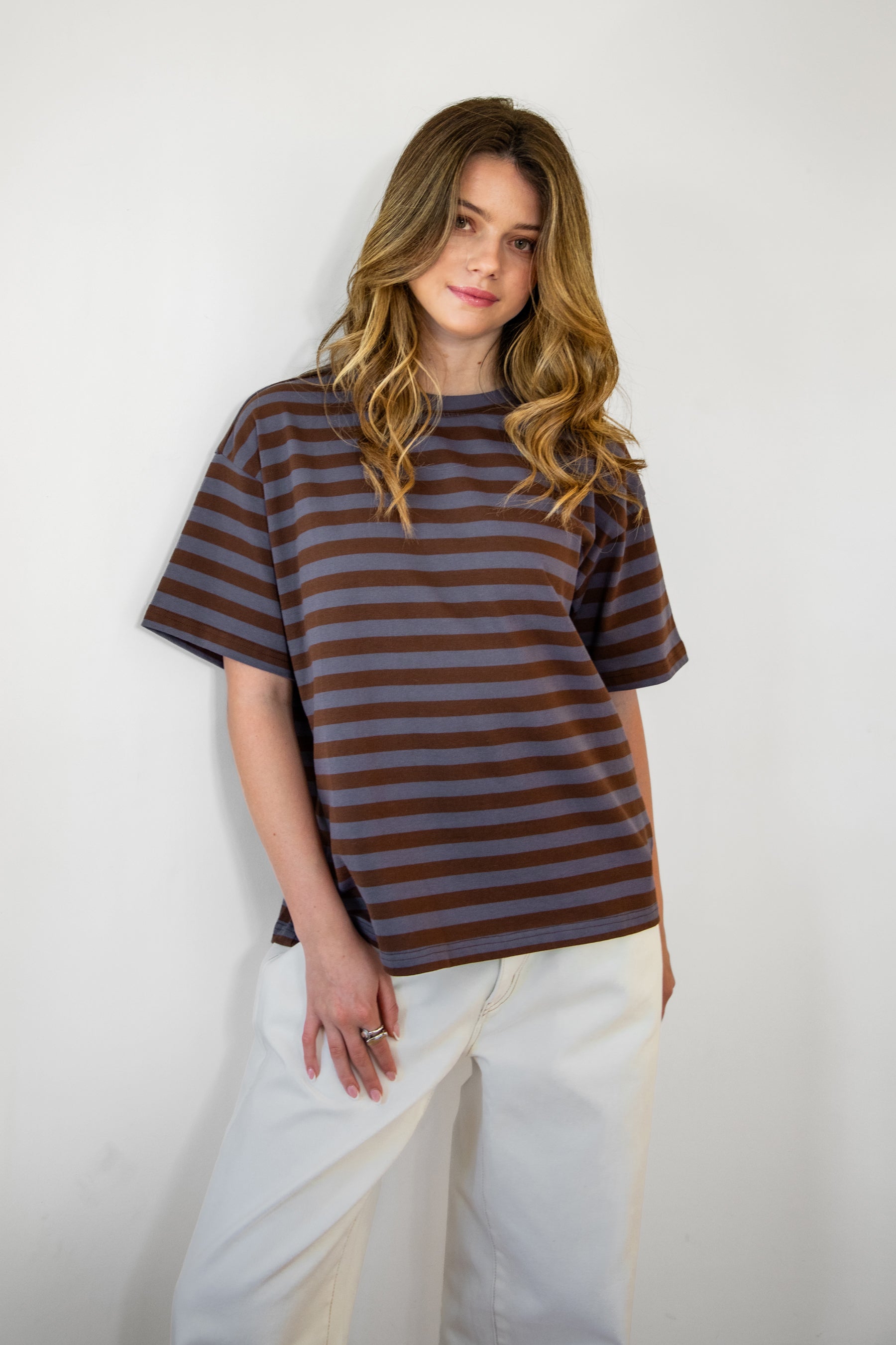 Woman wearing MARIN classic crewneck oversized striped short sleeve top featuring a timeless crew neckline, relaxed oversized fit, drop shoulder sleeves, soft horizontal stripe pattern, breathable 100% cotton fabric, and clean straight hem for everyday casual styling.