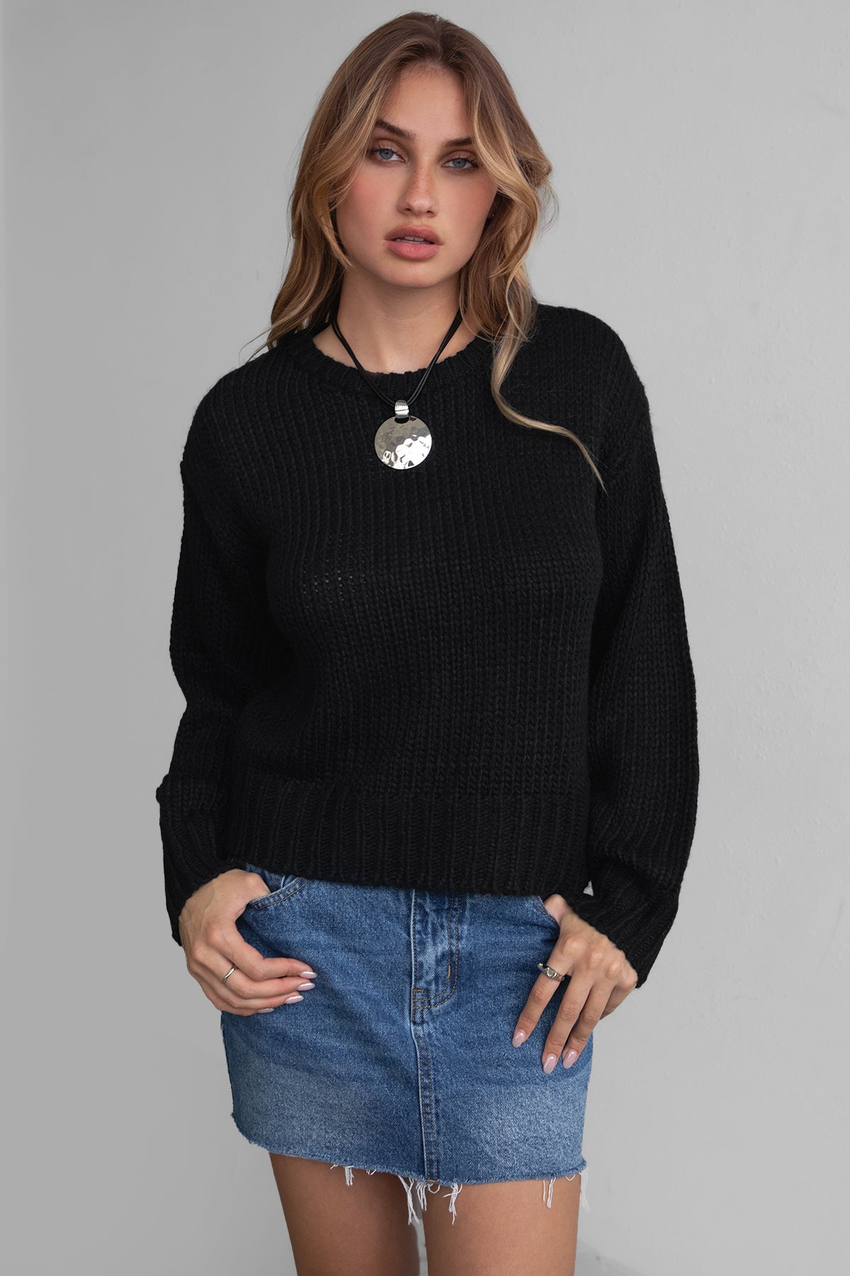 Model wearing TIC TOC KELLY Ribbed Knit Sweater in black Styled fall outfit with denim mini skirt