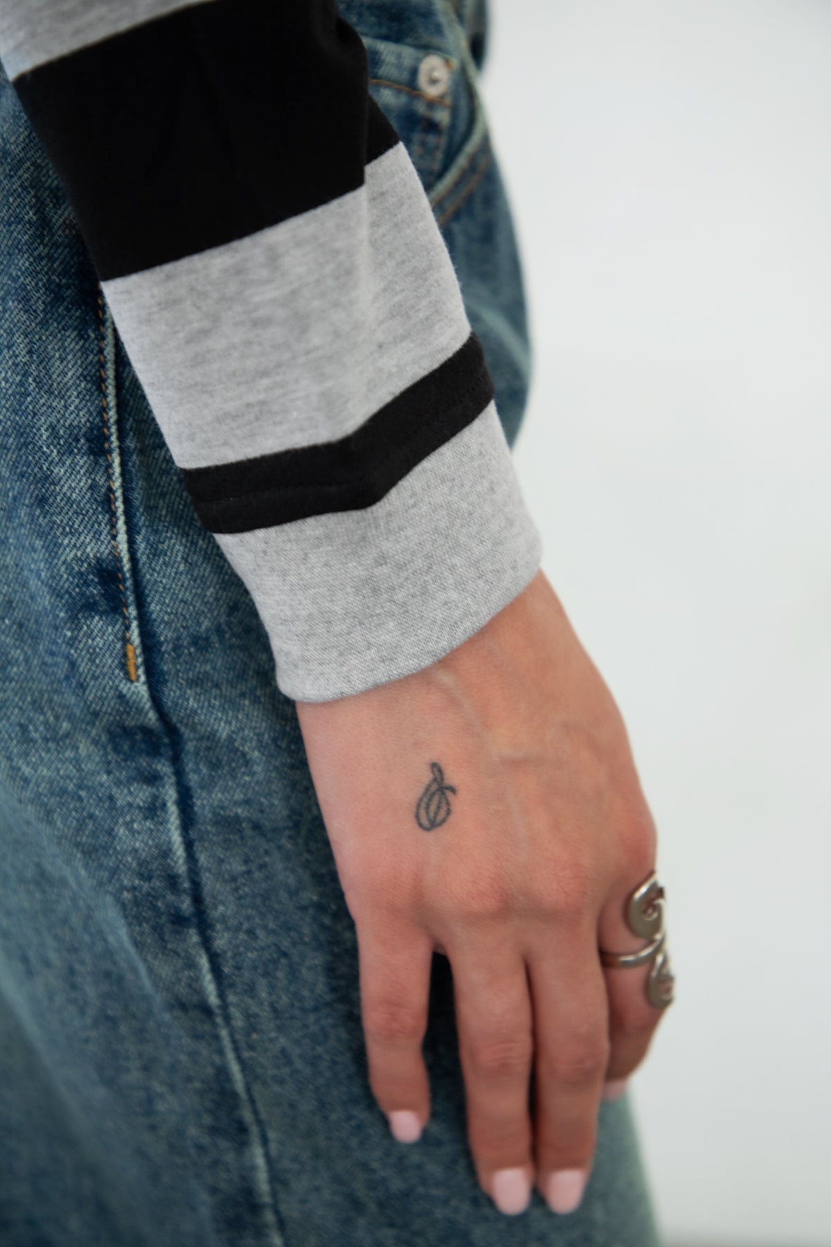 Woman wearing TIC TOC TOMMY Rugby Striped Long Sleeve Shirt in grey black sleeve detail