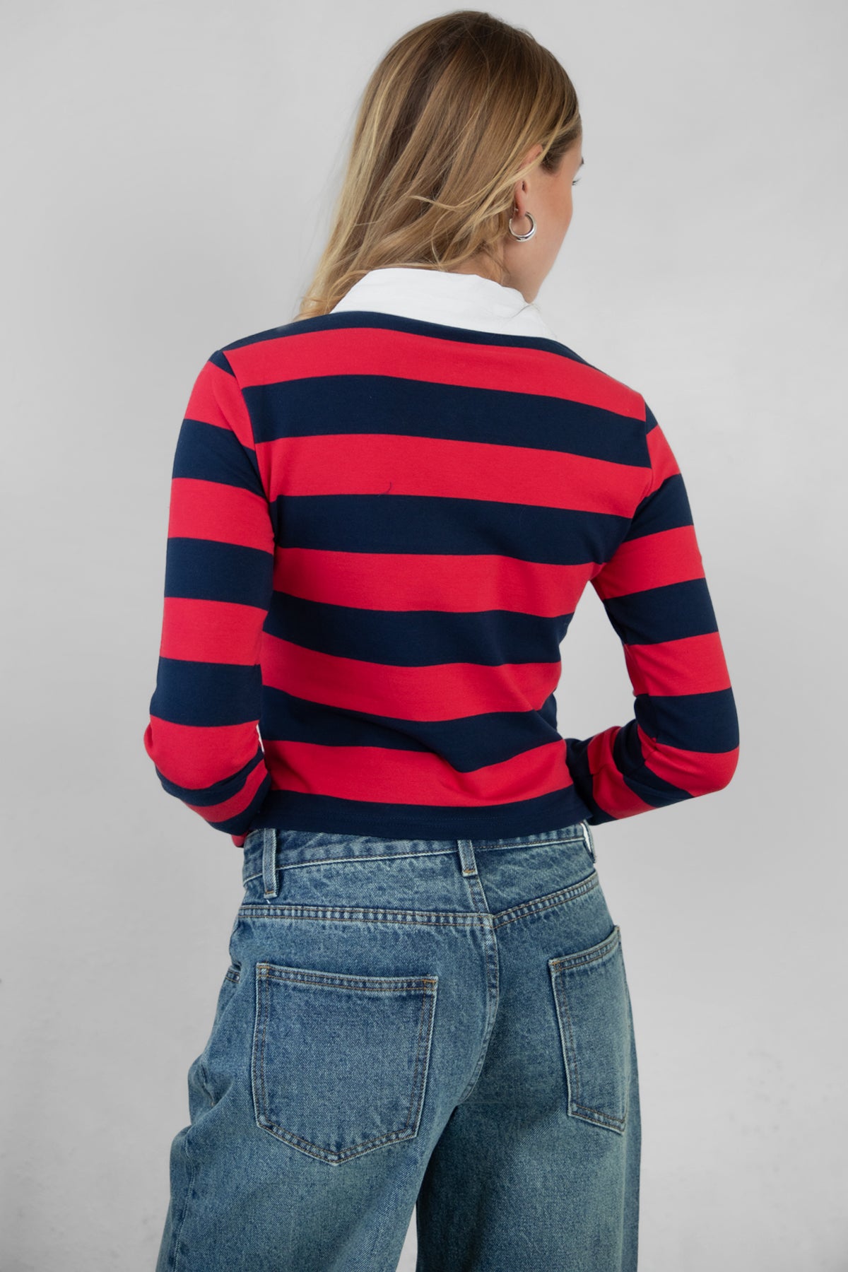 Woman wearing TIC TOC TOMMY Rugby Striped Long Sleeve Shirt in red navy with denim jeans, showing the back detail