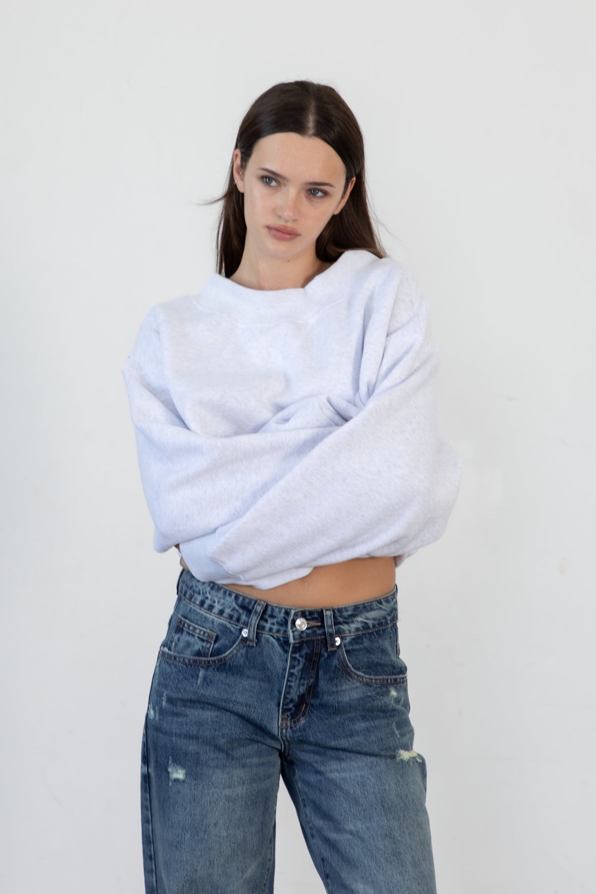 Woman wearing LANI mock neck cloud fleece sweatshirt featuring soft cotton blend cloud fleece fabric, ribbed mock neckline, relaxed oversized fit, dropped shoulder design, long sleeves with ribbed cuffs, triangle stitch detail at center front, and ribbed hem for a cozy comfortable finish.