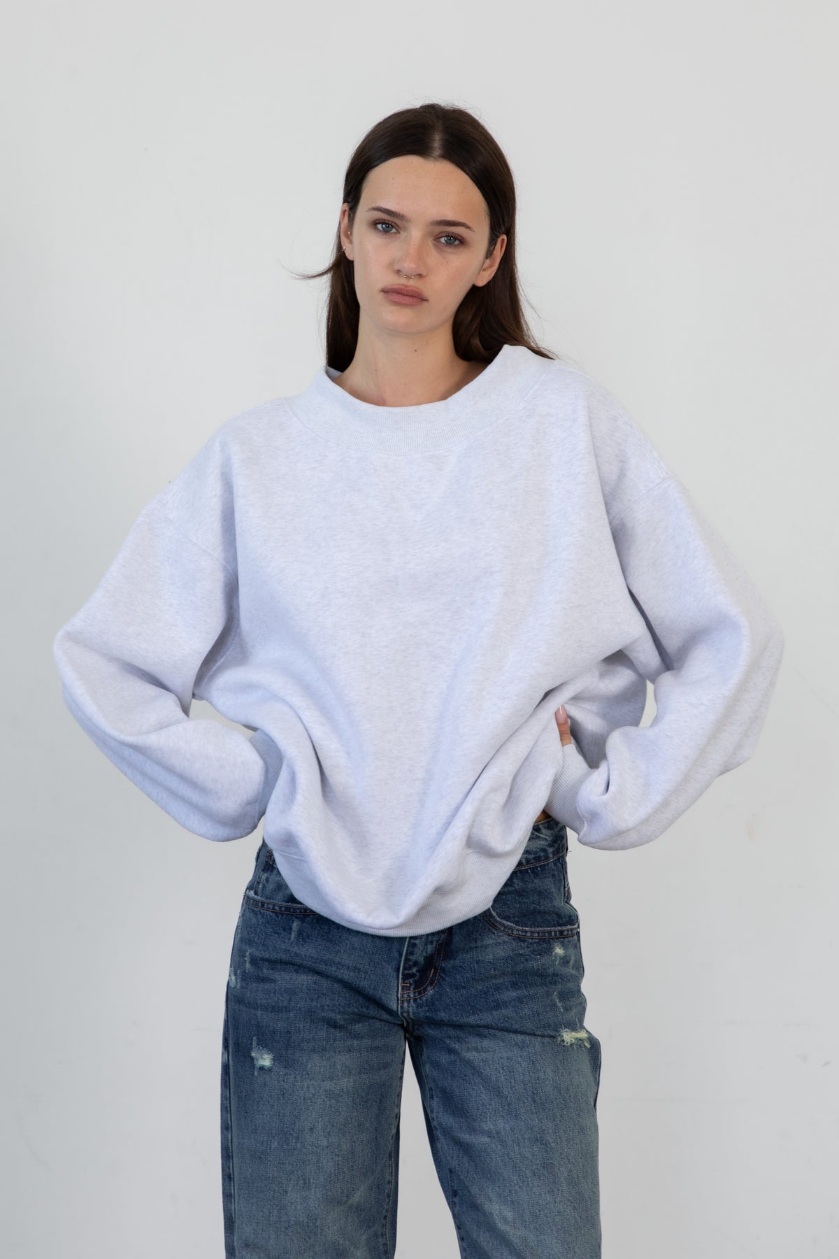 Woman wearing LANI mock neck cloud fleece sweatshirt featuring soft cotton blend cloud fleece fabric, ribbed mock neckline, relaxed oversized fit, dropped shoulder design, long sleeves with ribbed cuffs, triangle stitch detail at center front, and ribbed hem for a cozy comfortable finish.