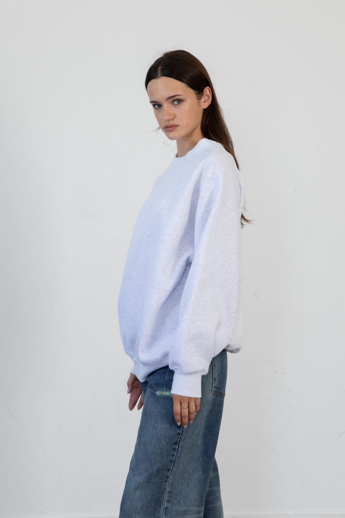 Woman wearing LANI mock neck cloud fleece sweatshirt featuring soft cotton blend cloud fleece fabric, ribbed mock neckline, relaxed oversized fit, dropped shoulder design, long sleeves with ribbed cuffs, triangle stitch detail at center front, and ribbed hem for a cozy comfortable finish.