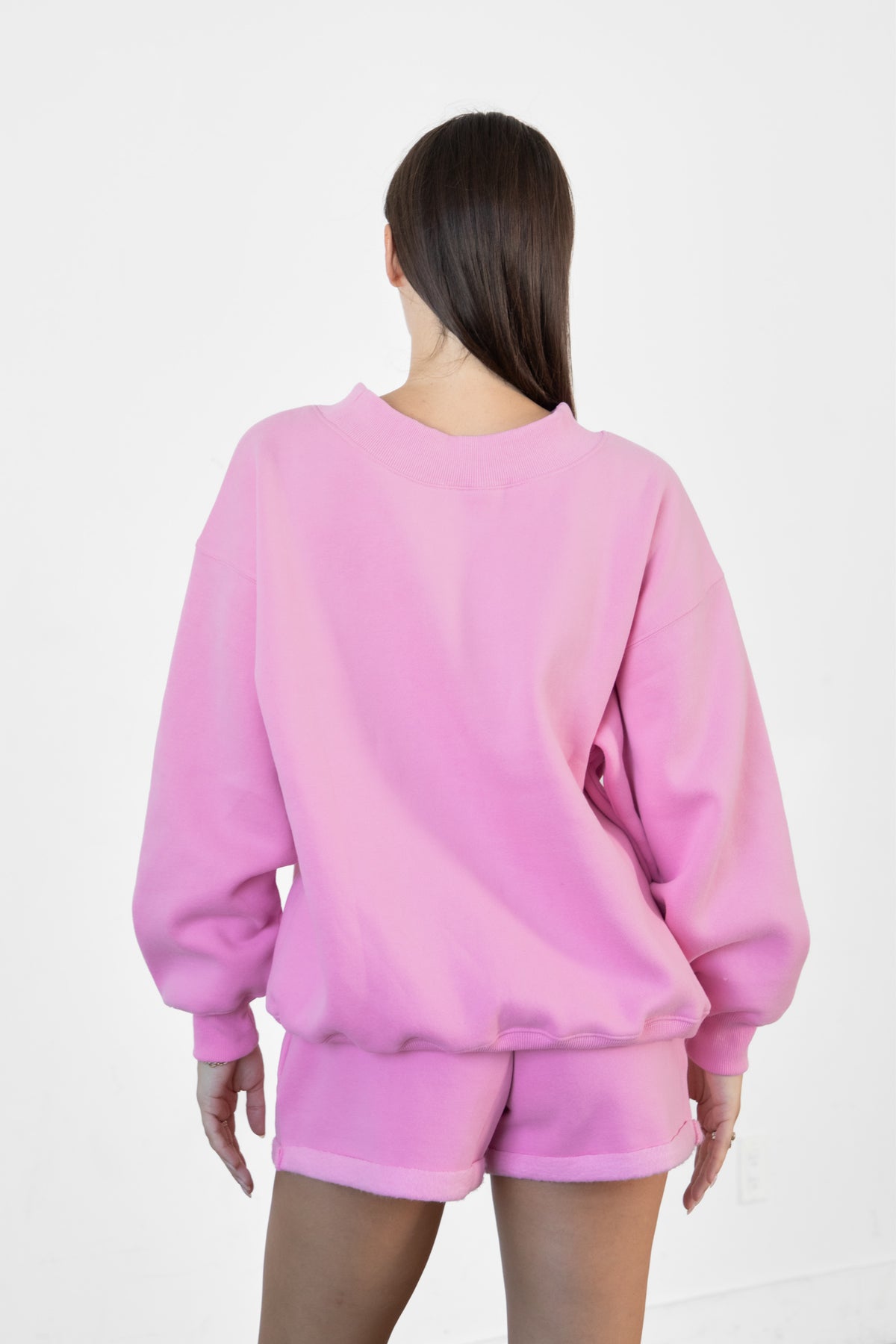 Woman wearing LANI mock neck cloud fleece sweatshirt featuring soft cotton blend cloud fleece fabric, ribbed mock neckline, relaxed oversized fit, dropped shoulder design, long sleeves with ribbed cuffs, triangle stitch detail at center front, and ribbed hem for a cozy comfortable finish.