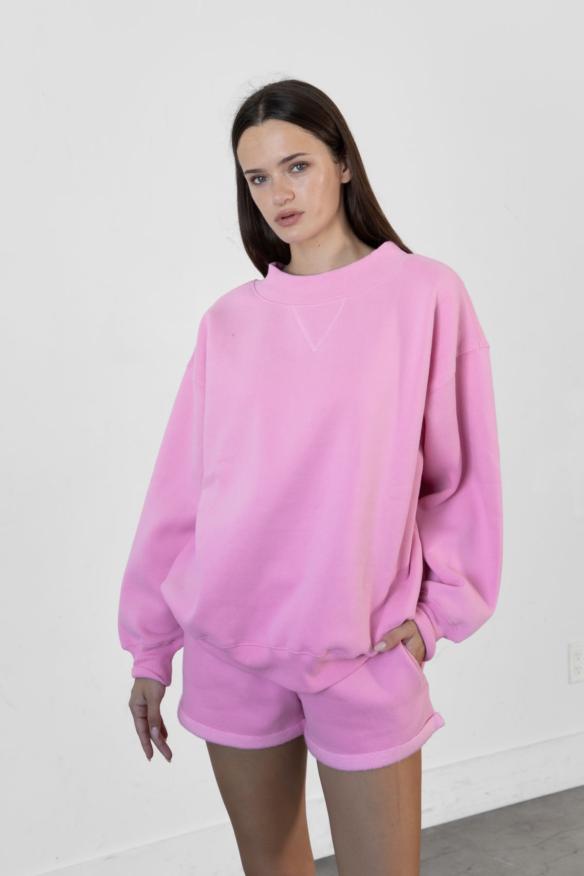 Woman wearing LANI mock neck cloud fleece sweatshirt featuring soft cotton blend cloud fleece fabric, ribbed mock neckline, relaxed oversized fit, dropped shoulder design, long sleeves with ribbed cuffs, triangle stitch detail at center front, and ribbed hem for a cozy comfortable finish.