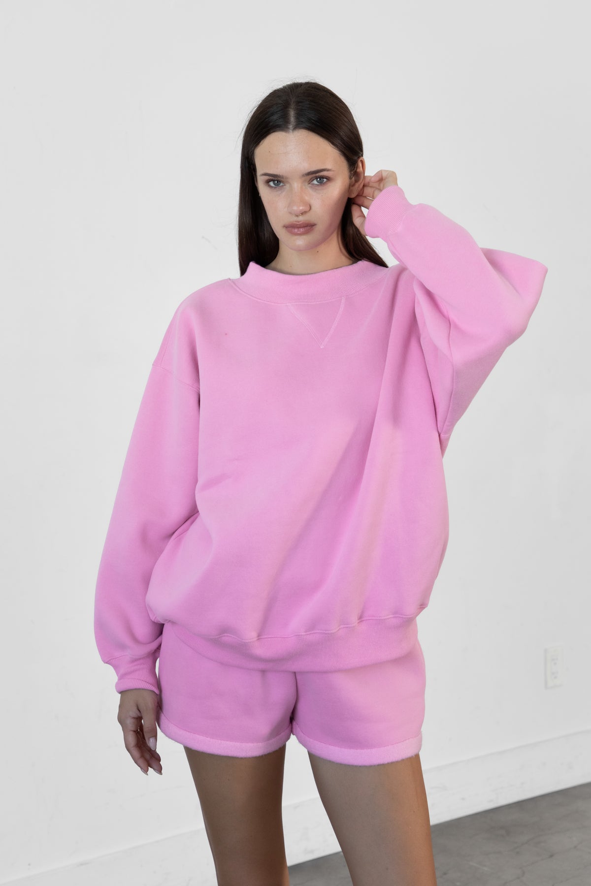 Woman wearing LANI mock neck cloud fleece sweatshirt featuring soft cotton blend cloud fleece fabric, ribbed mock neckline, relaxed oversized fit, dropped shoulder design, long sleeves with ribbed cuffs, triangle stitch detail at center front, and ribbed hem for a cozy comfortable finish.