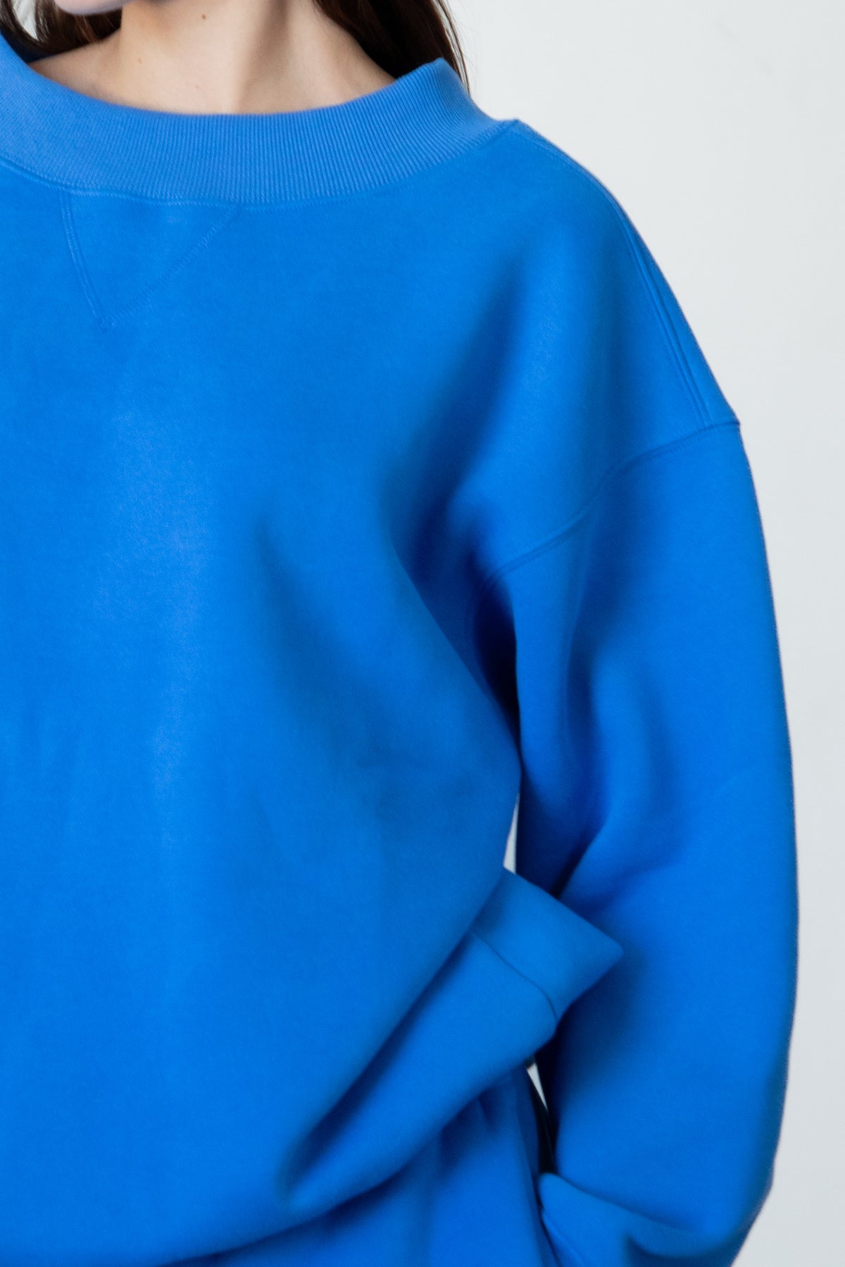 Woman wearing LANI mock neck cloud fleece sweatshirt featuring soft cotton blend cloud fleece fabric, ribbed mock neckline, relaxed oversized fit, dropped shoulder design, long sleeves with ribbed cuffs, triangle stitch detail at center front, and ribbed hem for a cozy comfortable finish.