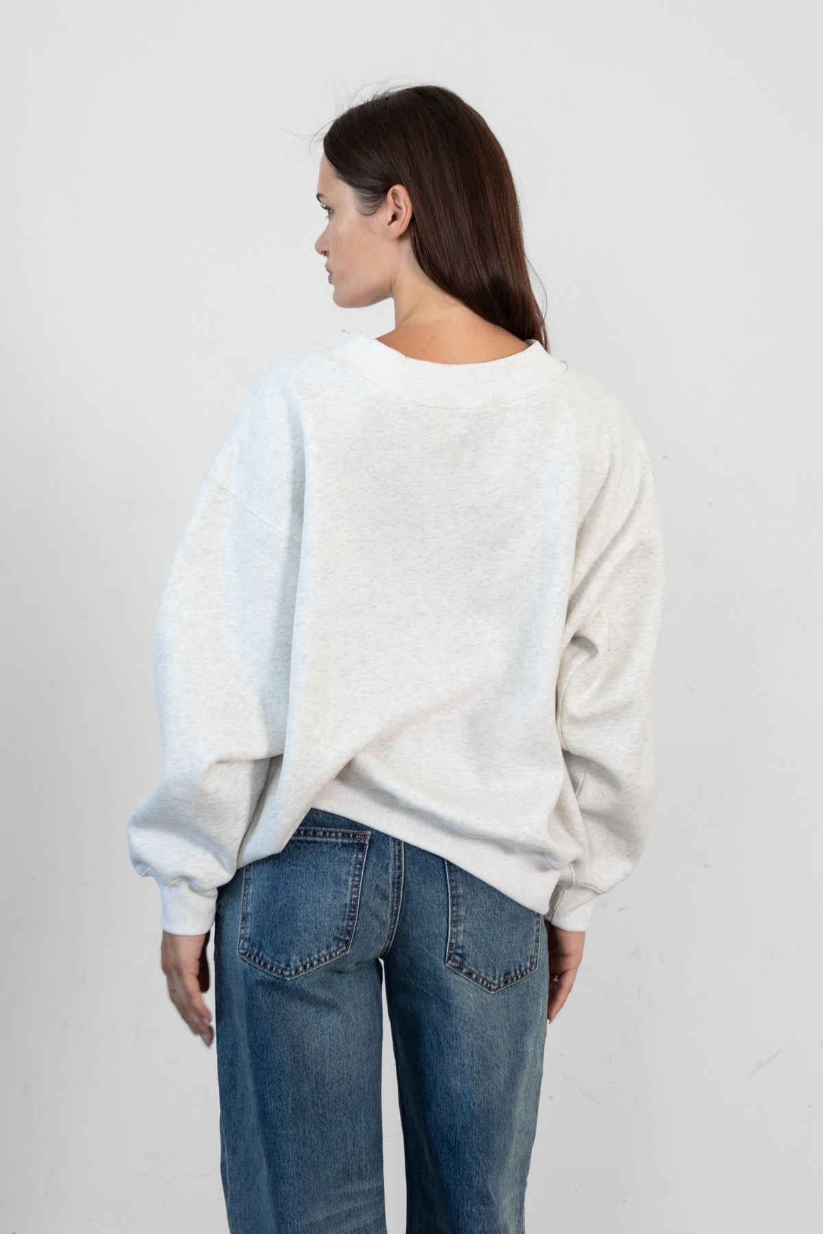 Woman wearing LANI mock neck cloud fleece sweatshirt featuring soft cotton blend cloud fleece fabric, ribbed mock neckline, relaxed oversized fit, dropped shoulder design, long sleeves with ribbed cuffs, triangle stitch detail at center front, and ribbed hem for a cozy comfortable finish.
