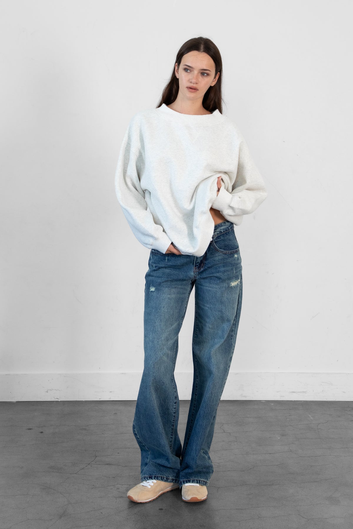Woman wearing LANI mock neck cloud fleece sweatshirt featuring soft cotton blend cloud fleece fabric, ribbed mock neckline, relaxed oversized fit, dropped shoulder design, long sleeves with ribbed cuffs, triangle stitch detail at center front, and ribbed hem for a cozy comfortable finish.