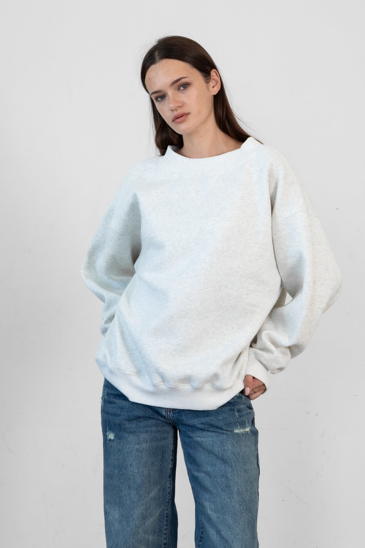 Woman wearing LANI mock neck cloud fleece sweatshirt featuring soft cotton blend cloud fleece fabric, ribbed mock neckline, relaxed oversized fit, dropped shoulder design, long sleeves with ribbed cuffs, triangle stitch detail at center front, and ribbed hem for a cozy comfortable finish.
