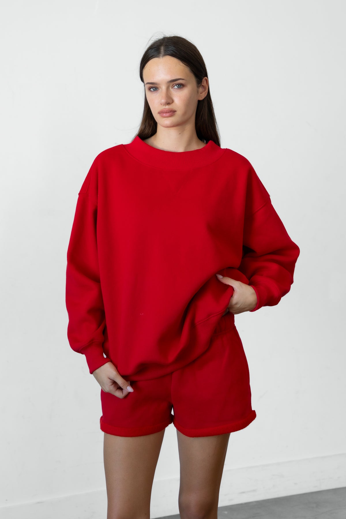 Woman wearing LANI mock neck cloud fleece sweatshirt featuring soft cotton blend cloud fleece fabric, ribbed mock neckline, relaxed oversized fit, dropped shoulder design, long sleeves with ribbed cuffs, triangle stitch detail at center front, and ribbed hem for a cozy comfortable finish.