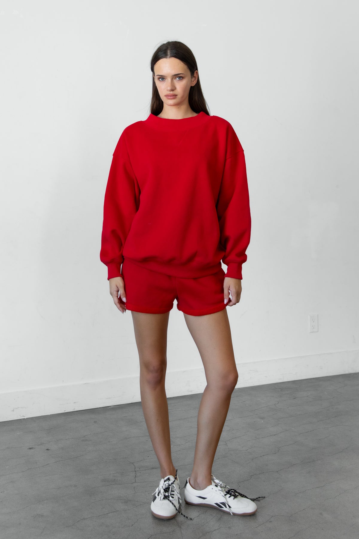Woman wearing LANI mock neck cloud fleece sweatshirt featuring soft cotton blend cloud fleece fabric, ribbed mock neckline, relaxed oversized fit, dropped shoulder design, long sleeves with ribbed cuffs, triangle stitch detail at center front, and ribbed hem for a cozy comfortable finish.