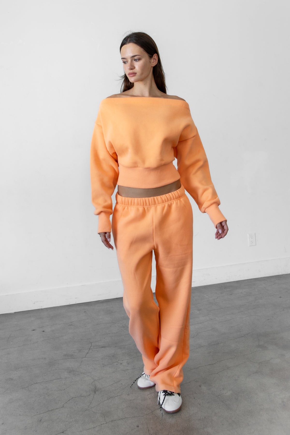 Woman wearing LANI mock neck cloud fleece sweatshirt featuring soft cotton blend cloud fleece fabric, ribbed mock neckline, relaxed oversized fit, dropped shoulder design, long sleeves with ribbed cuffs, triangle stitch detail at center front, and ribbed hem for a cozy comfortable finish.