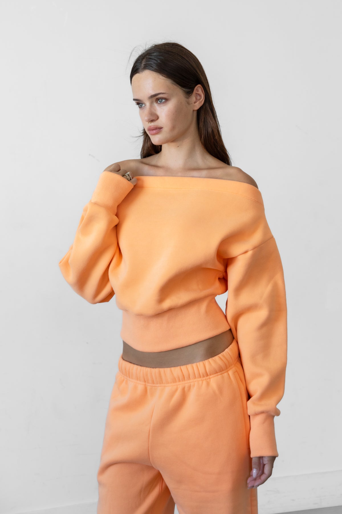Woman wearing LANI mock neck cloud fleece sweatshirt featuring soft cotton blend cloud fleece fabric, ribbed mock neckline, relaxed oversized fit, dropped shoulder design, long sleeves with ribbed cuffs, triangle stitch detail at center front, and ribbed hem for a cozy comfortable finish.