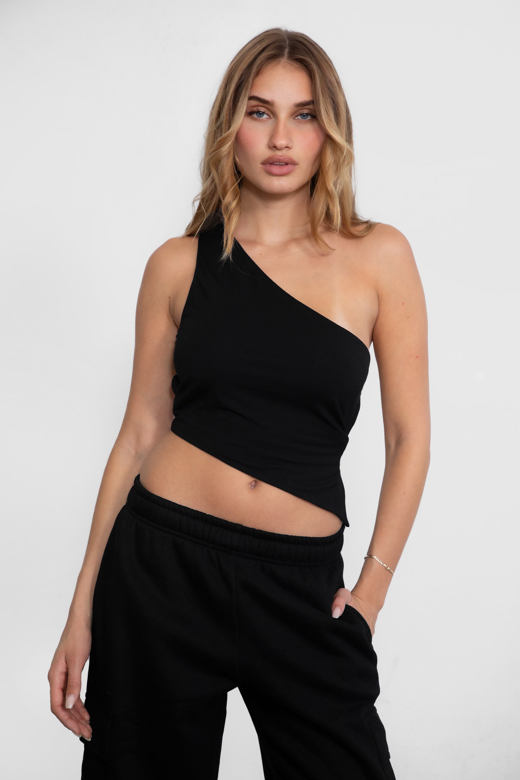TIC TOC JIJI One Shoulder Asymmetrical Tank Top in black with open back, long angled hem, and adjustable tie closures.