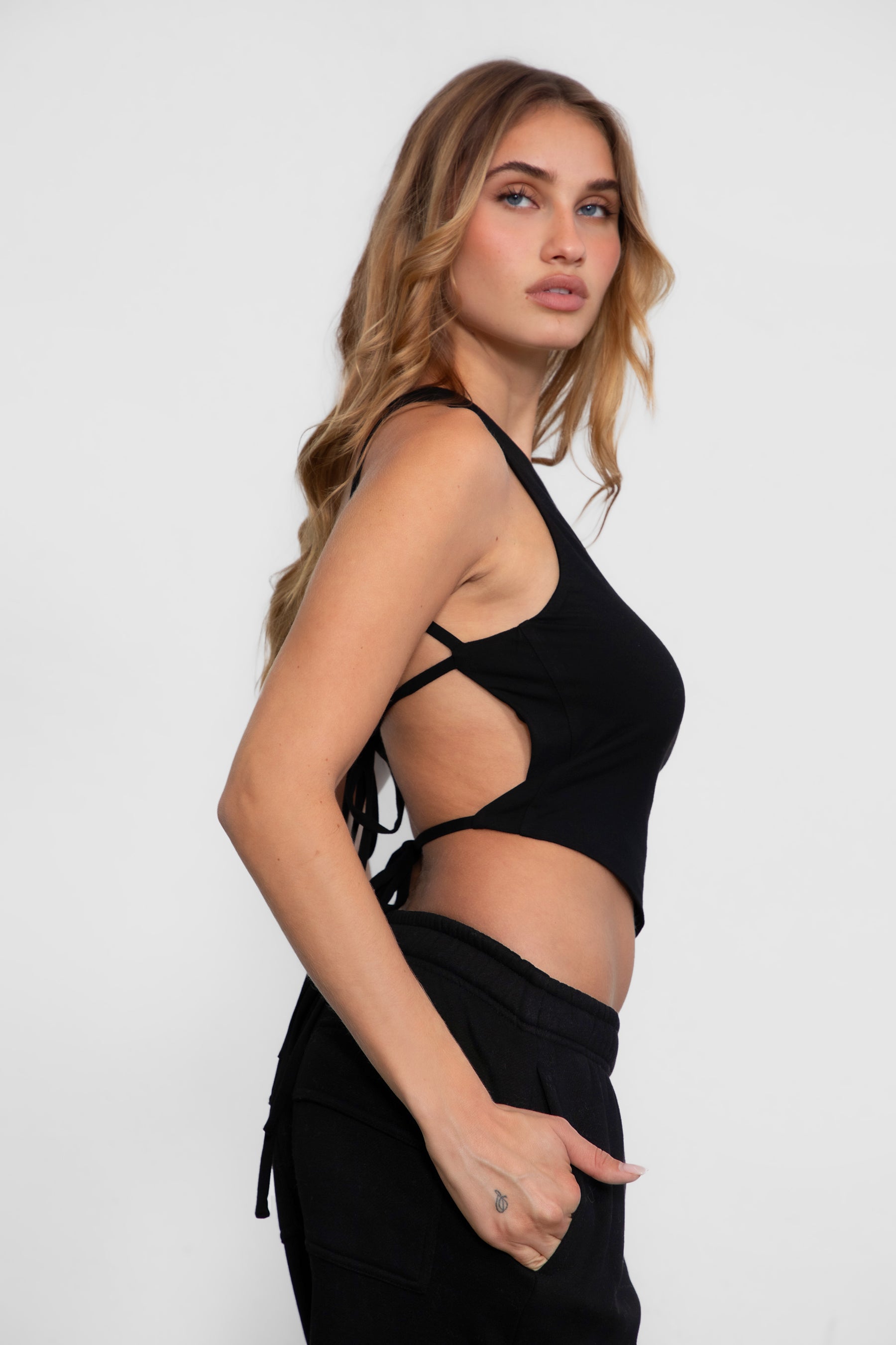 TIC TOC JIJI One Shoulder Asymmetrical Tank Top in black with open back, long angled hem, and adjustable tie closures.