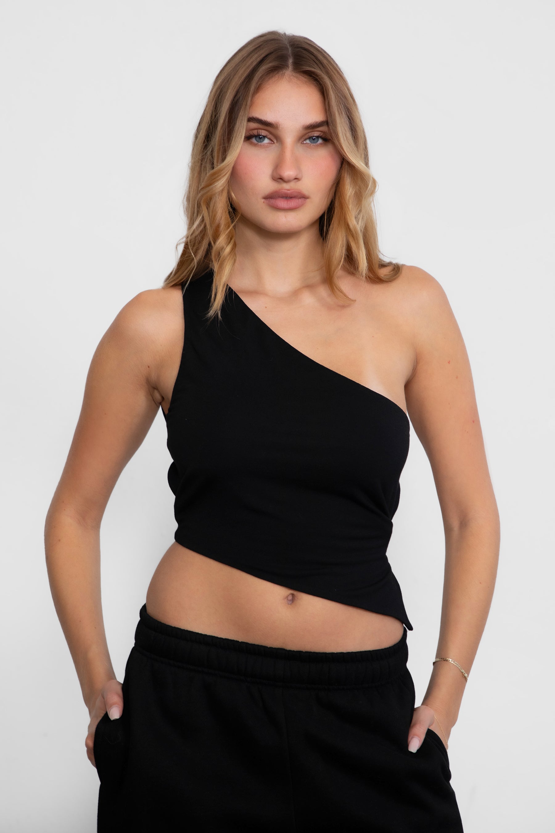 TIC TOC JIJI One Shoulder Asymmetrical Tank Top in black with open back, long angled hem, and adjustable tie closures.