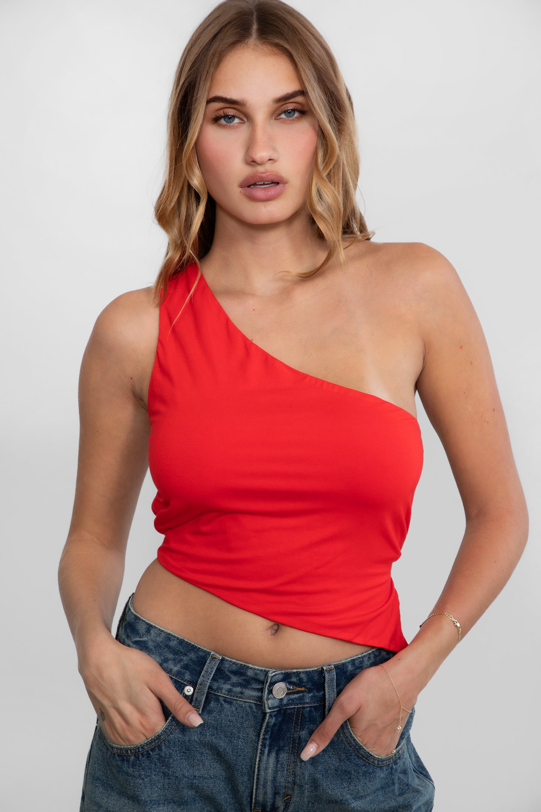 TIC TOC JIJI One Shoulder Asymmetrical Tank Top in Red with open back, long angled hem, and adjustable tie closures.
