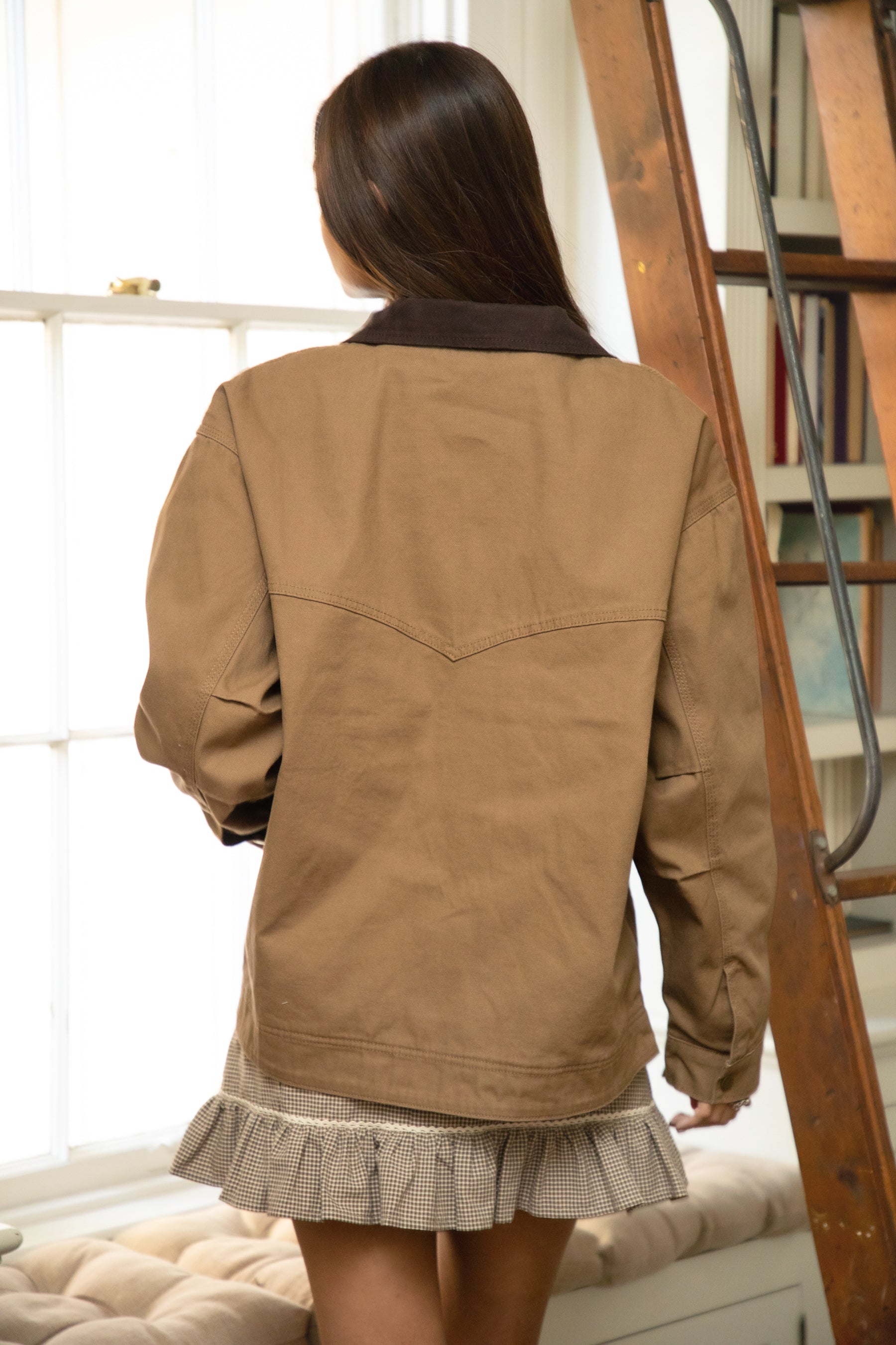 Woman wearing TIC TOC TT31817-SABLETON SABLETON oversized canvas twill jacket featuring an oversized vintage fit, front zip closure, contrast corduroy collar, two side pockets, snap button cuffs with drop shoulder fit, and chest and back stitched detailing, styled over casual basics for a western-inspired everyday transitional look.