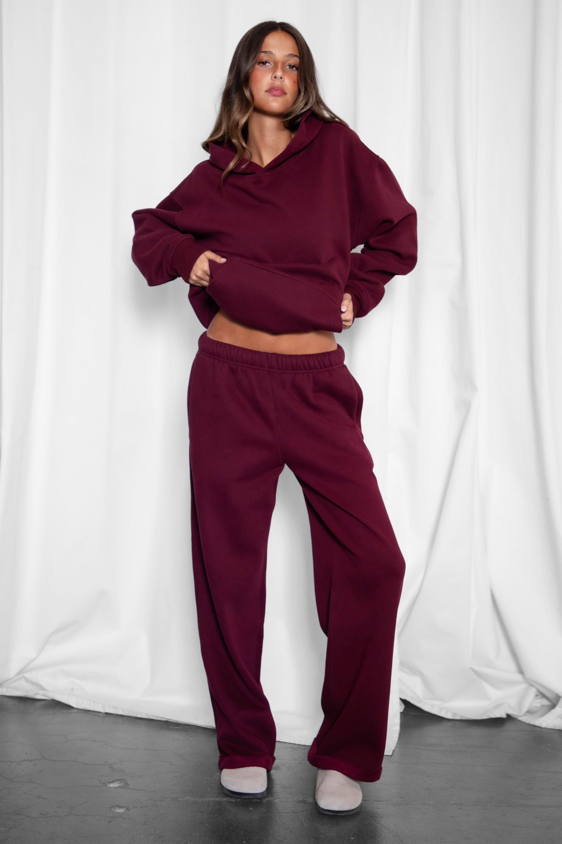 Woman wearing the TIC TOC PJ30241 LANI black cherry cloud fleece wide leg sweatpants featuring a straight leg silhouette, drawcord waistband, and side pockets paired with a matching hoodie. 