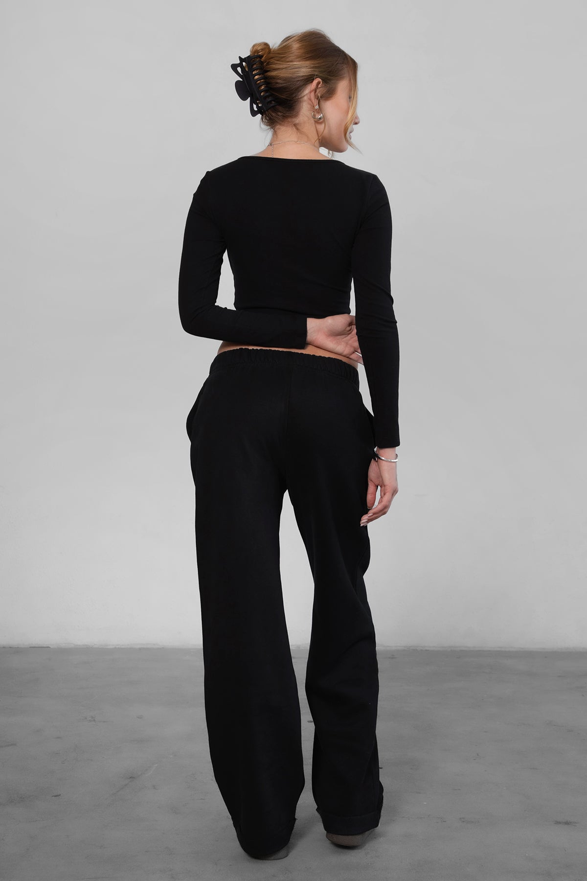 Woman wearing the TIC TOC PJ30241 LANI black cloud fleece wide leg sweatpants featuring a straight leg silhouette, drawcord waistband, and side pockets paired with a matching top.