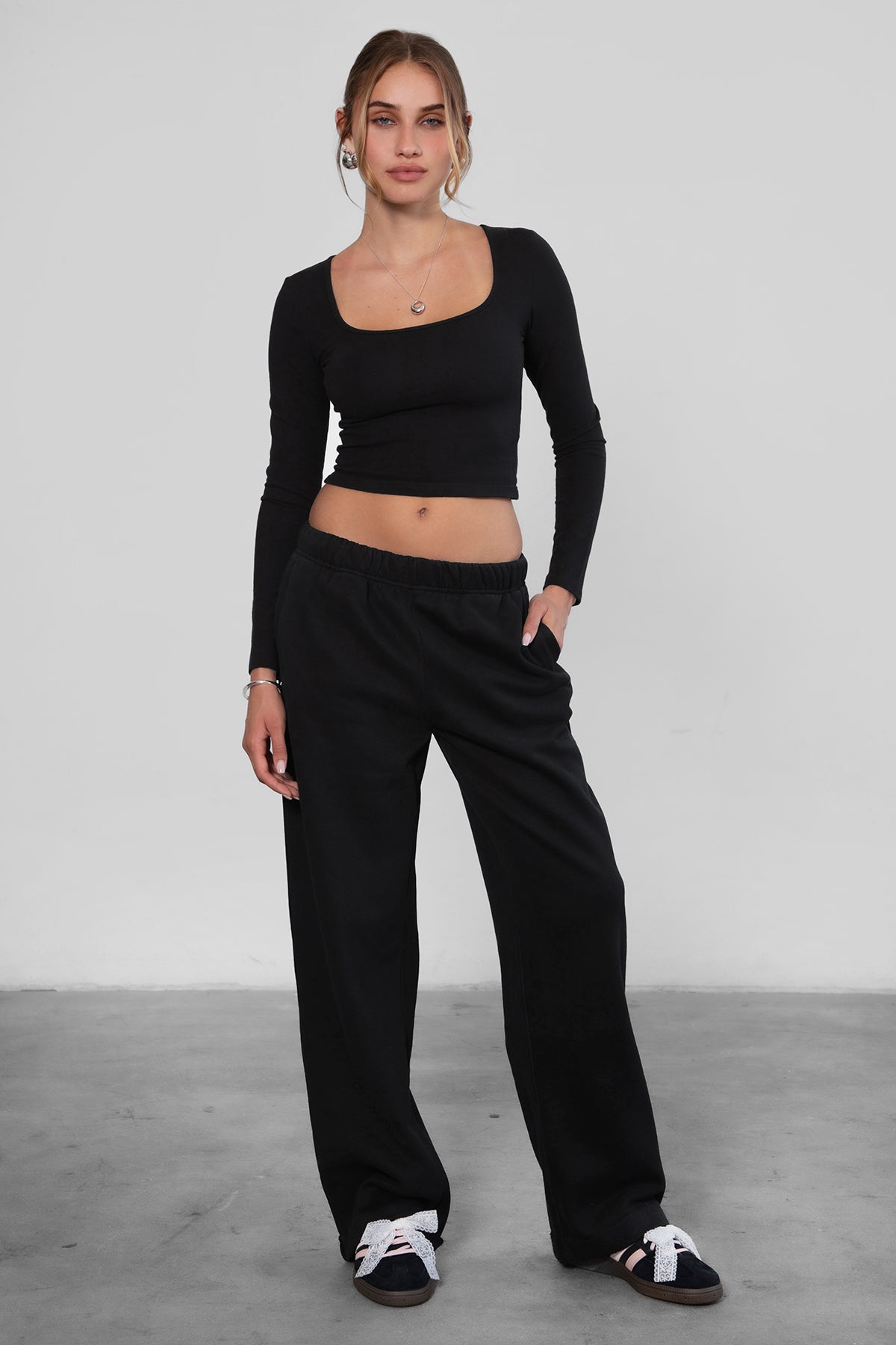 Woman wearing the TIC TOC PJ30241 LANI black cloud fleece wide leg sweatpants featuring a straight leg silhouette, drawcord waistband, and side pockets paired with a matching top.