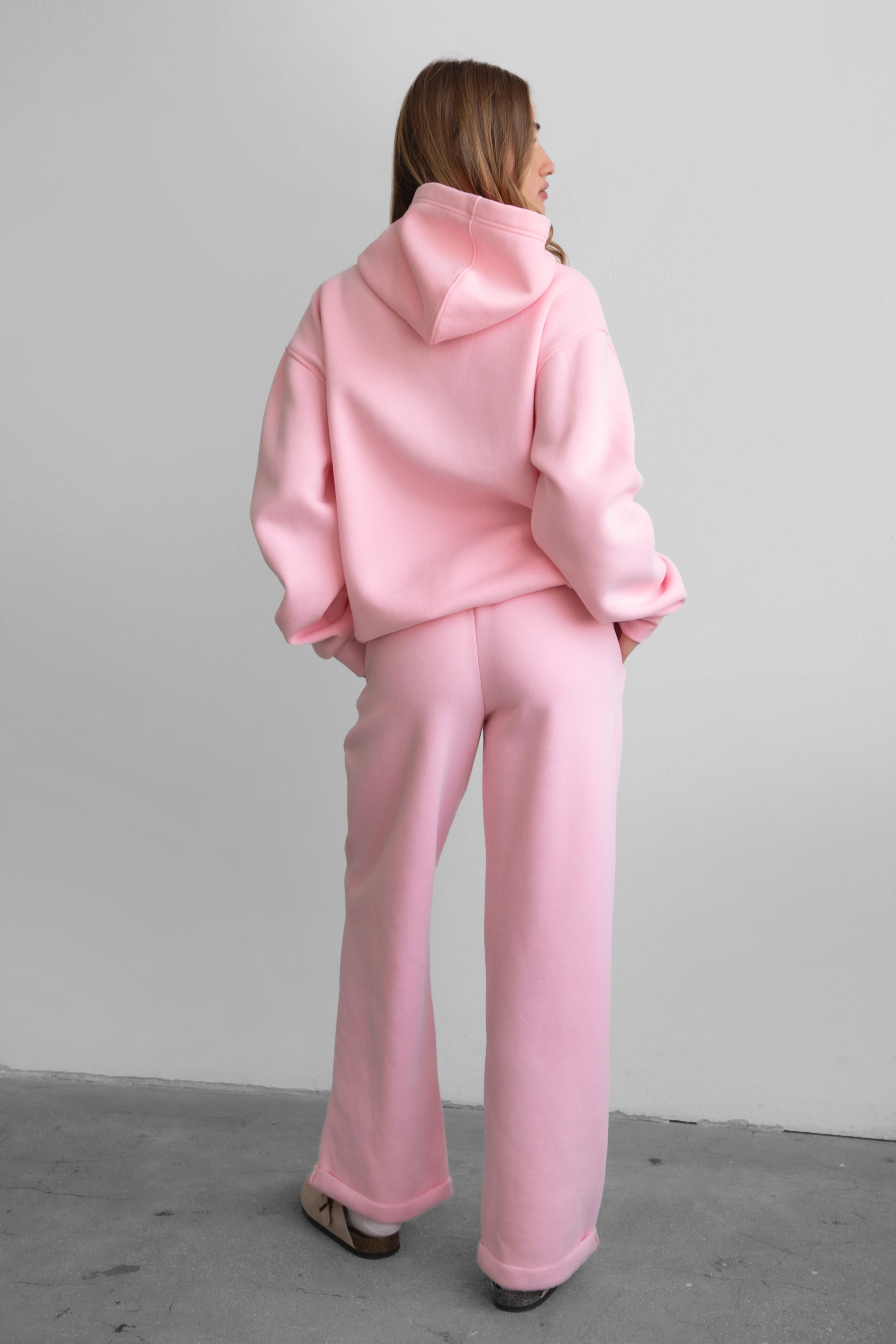 Woman wearing the TIC TOC PJ30241 LANI blush cloud fleece wide leg sweatpants featuring a straight leg silhouette, drawcord waistband, and side pockets paired with a matching hoodie.