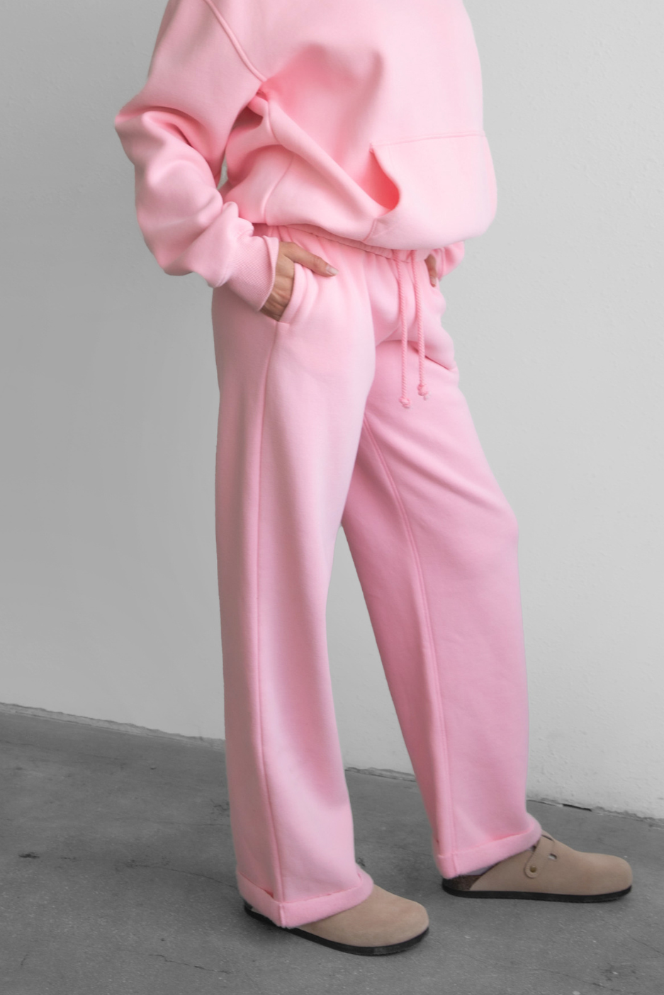 Woman wearing the TIC TOC PJ30241 LANI blush cloud fleece wide leg sweatpants featuring a straight leg silhouette, drawcord waistband, and side pockets paired with a matching hoodie.