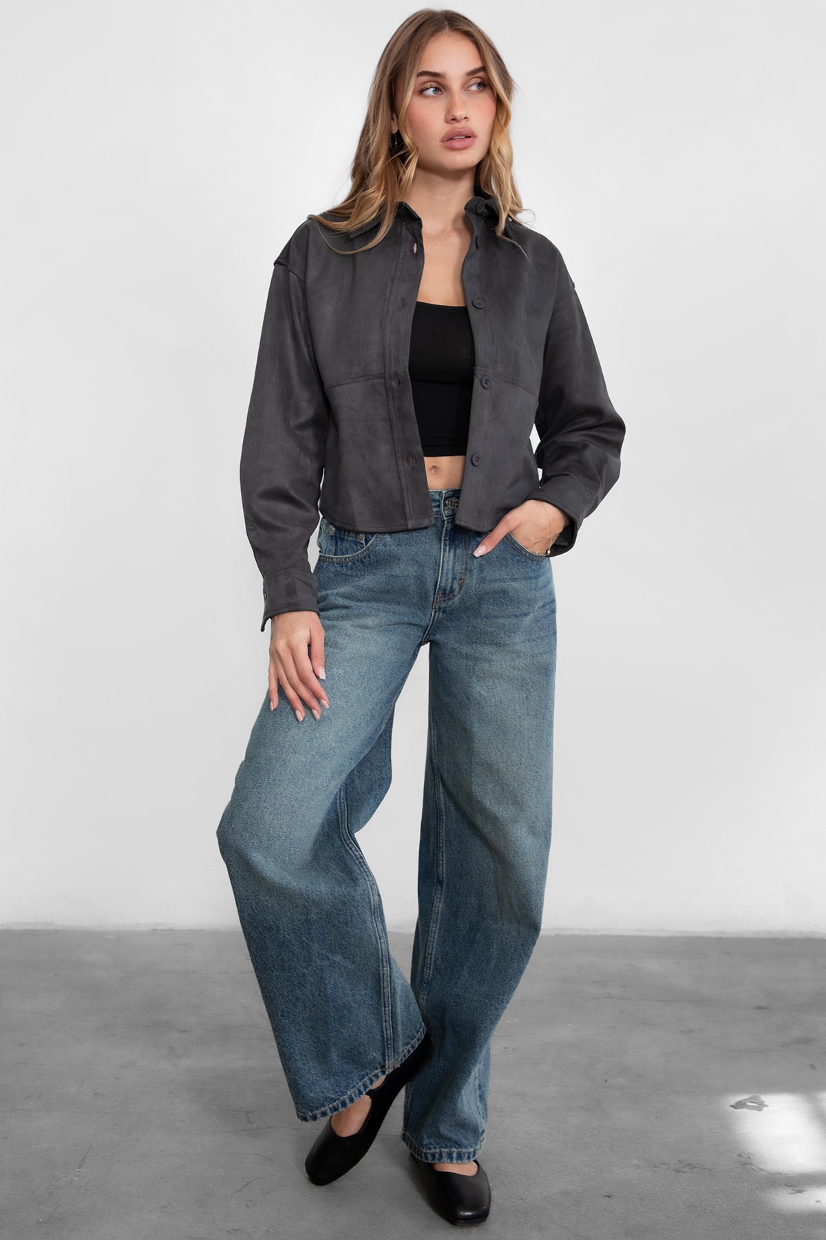 Woman wearing TIC TOC PJ30350 WINSLEY low rise straight leg denim jeans in vintage blue wash with wide leg fit paired a grey shacket and flats. 
