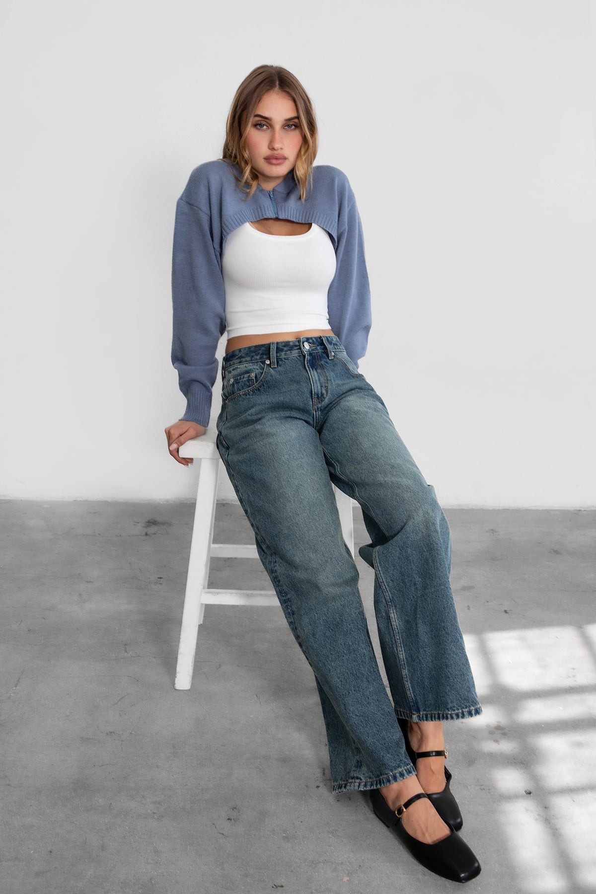 Woman wearing TIC TOC TC29152 FREYA ultra cropped hooded cardigan with ribbed knit fabric and double ended zipper in french blue