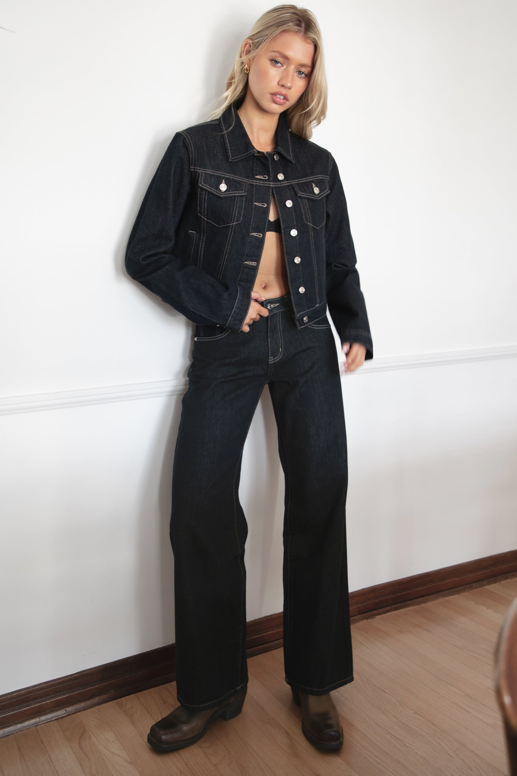 Model wearing TIC TOC TF31704 MILLS  selvedge denim jacket in dark blue wash with structured fit and contrast stitching with matching denim jeans in an indoor setting. 