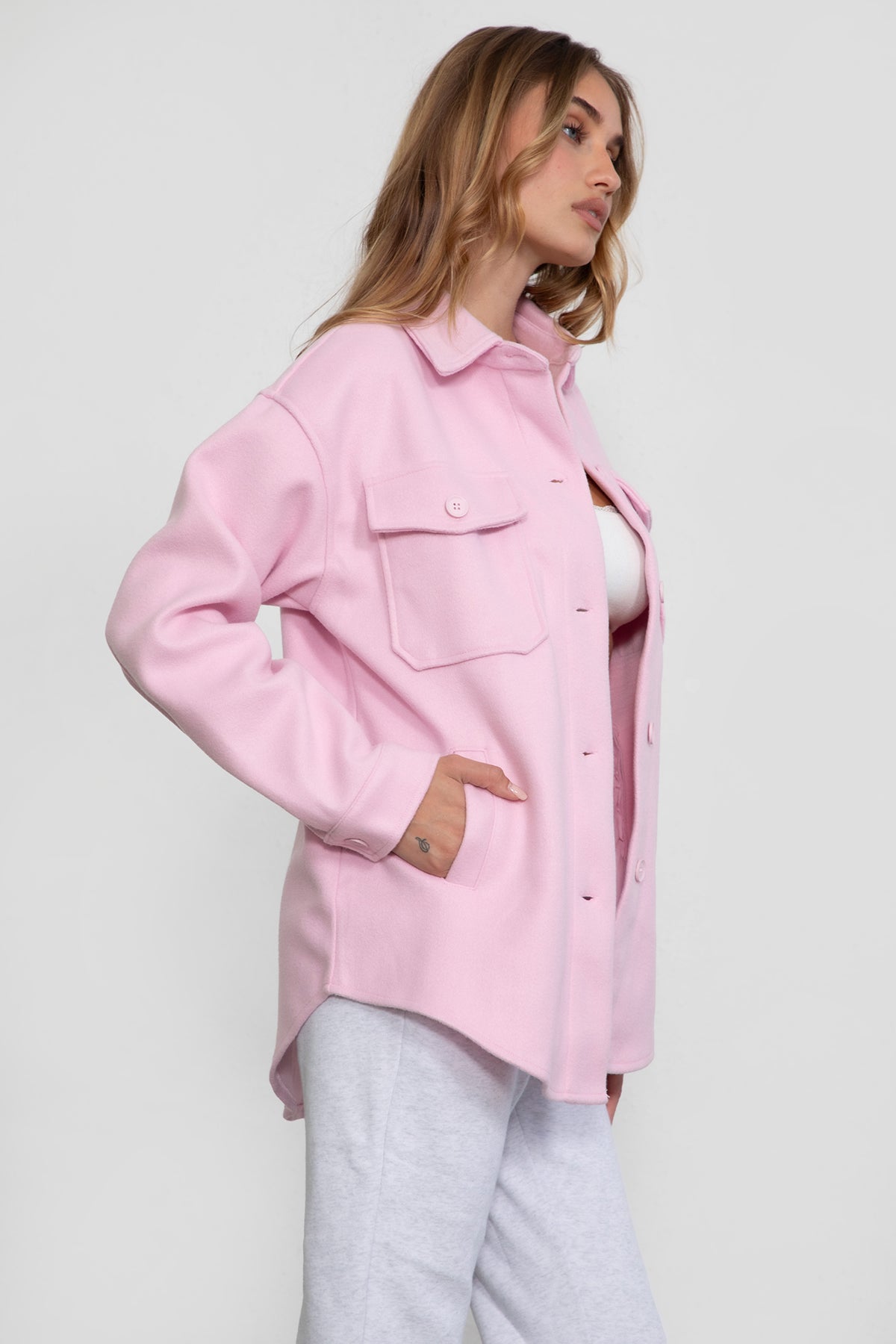Woman wearing TIC TOC TH29148 BIRKEN faux wool oversized shirt shacket with button front and double pockets in color blush pairedwith lounge top and sweats