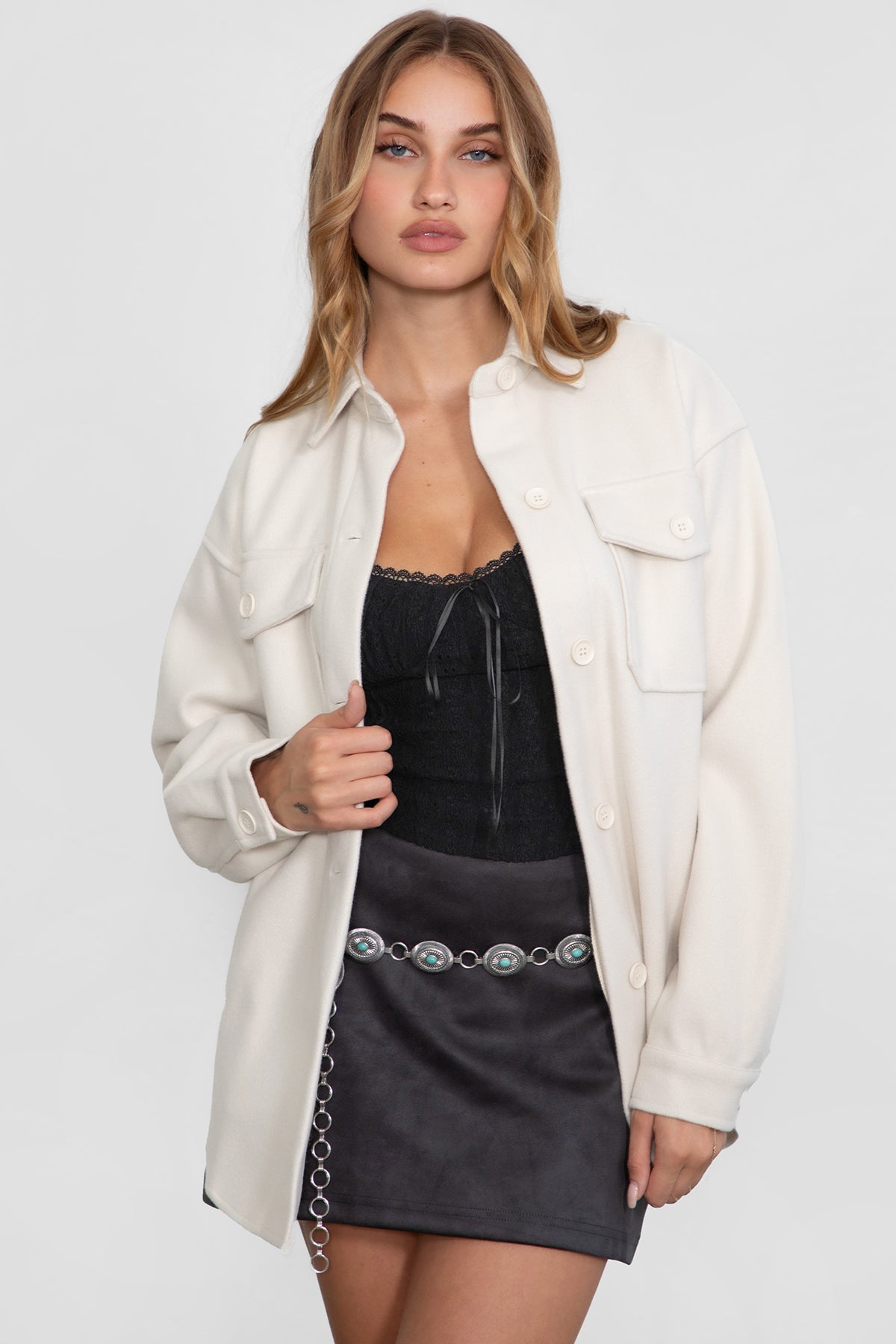 Woman wearing TIC TOC TH29148 BIRKEN faux wool oversized shirt shacket with button front and double pockets in color cream paired in a western way.