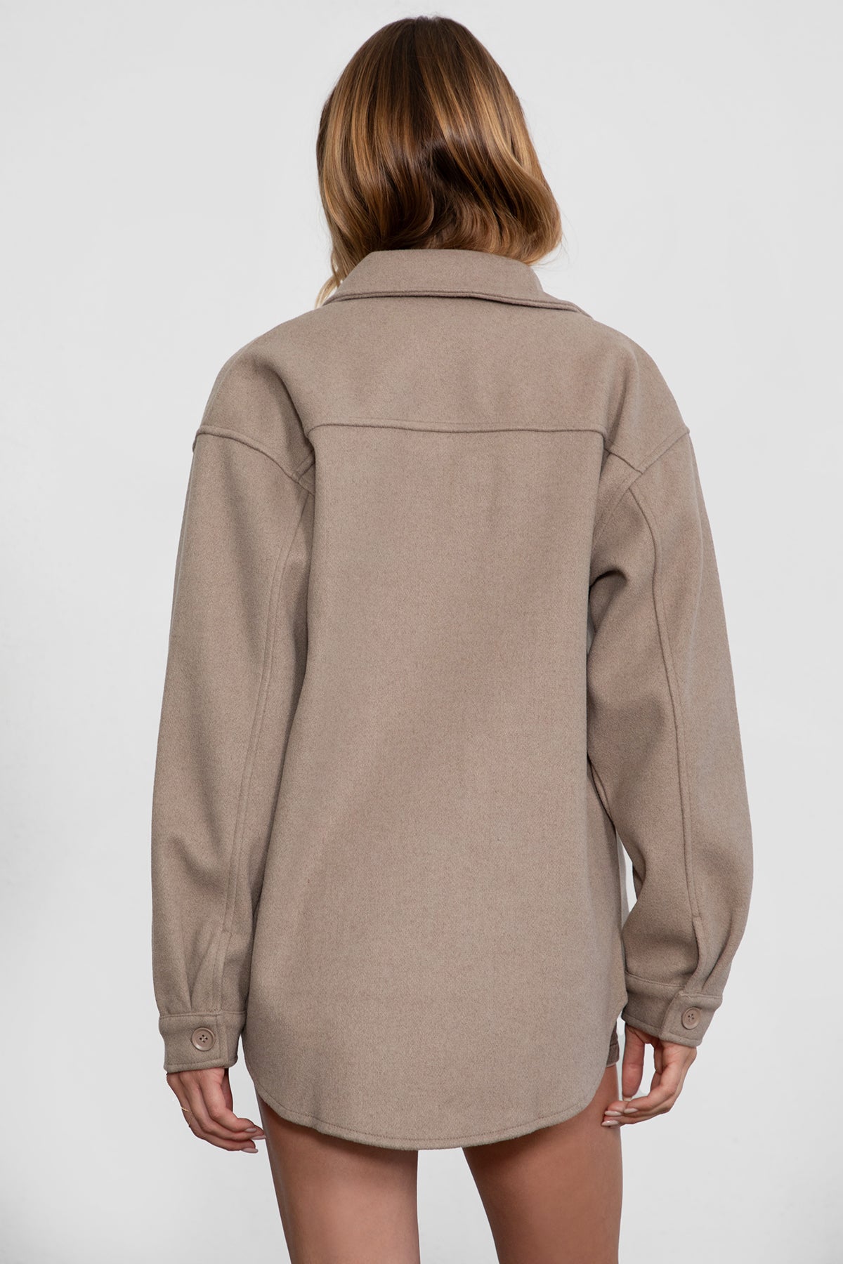 Woman wearing TIC TOC TH29148 BIRKEN faux wool oversized shirt shacket with button front and double pockets in color taupe paired with a brown mini skirt